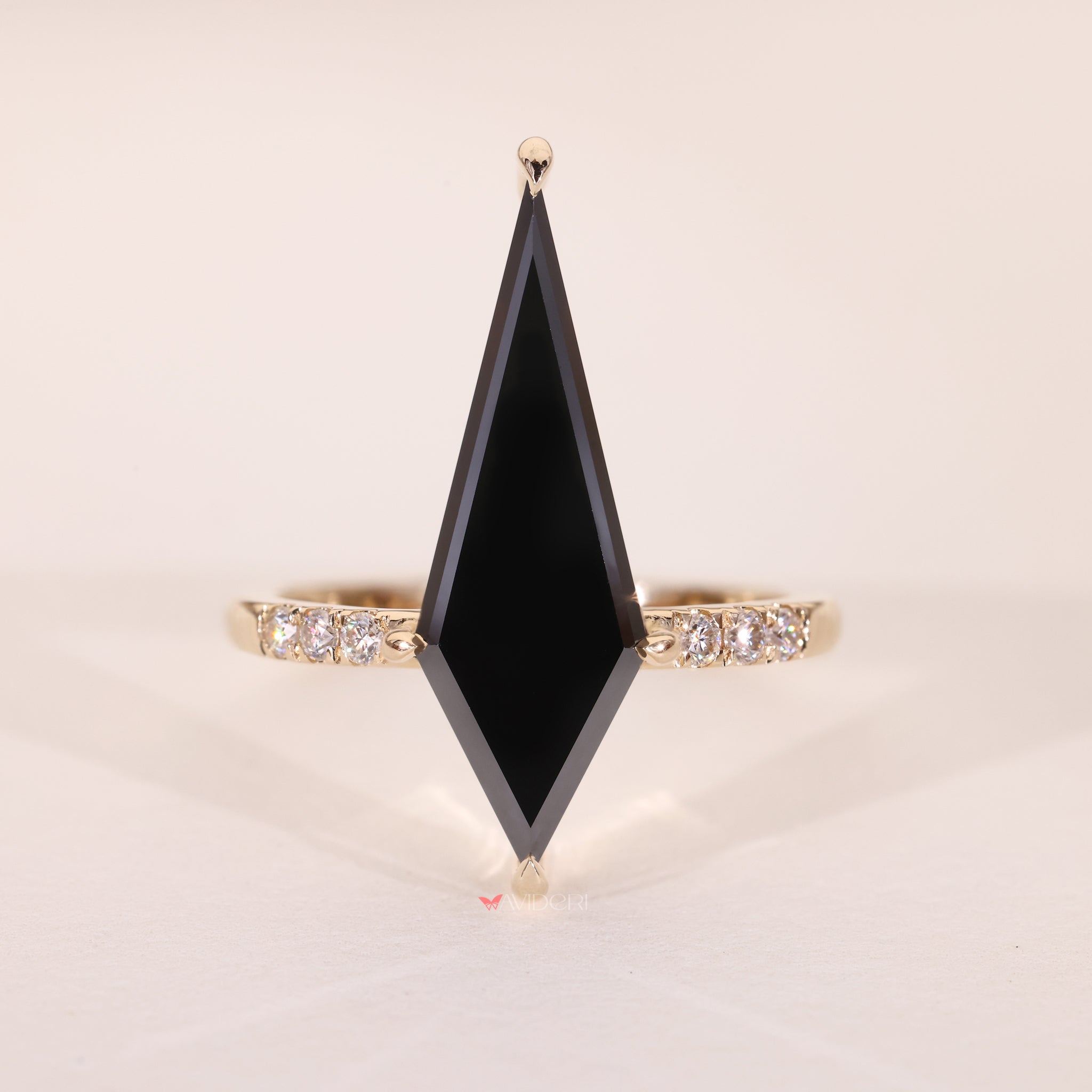 Round side pave ring with moissanite accents on a gold band.
