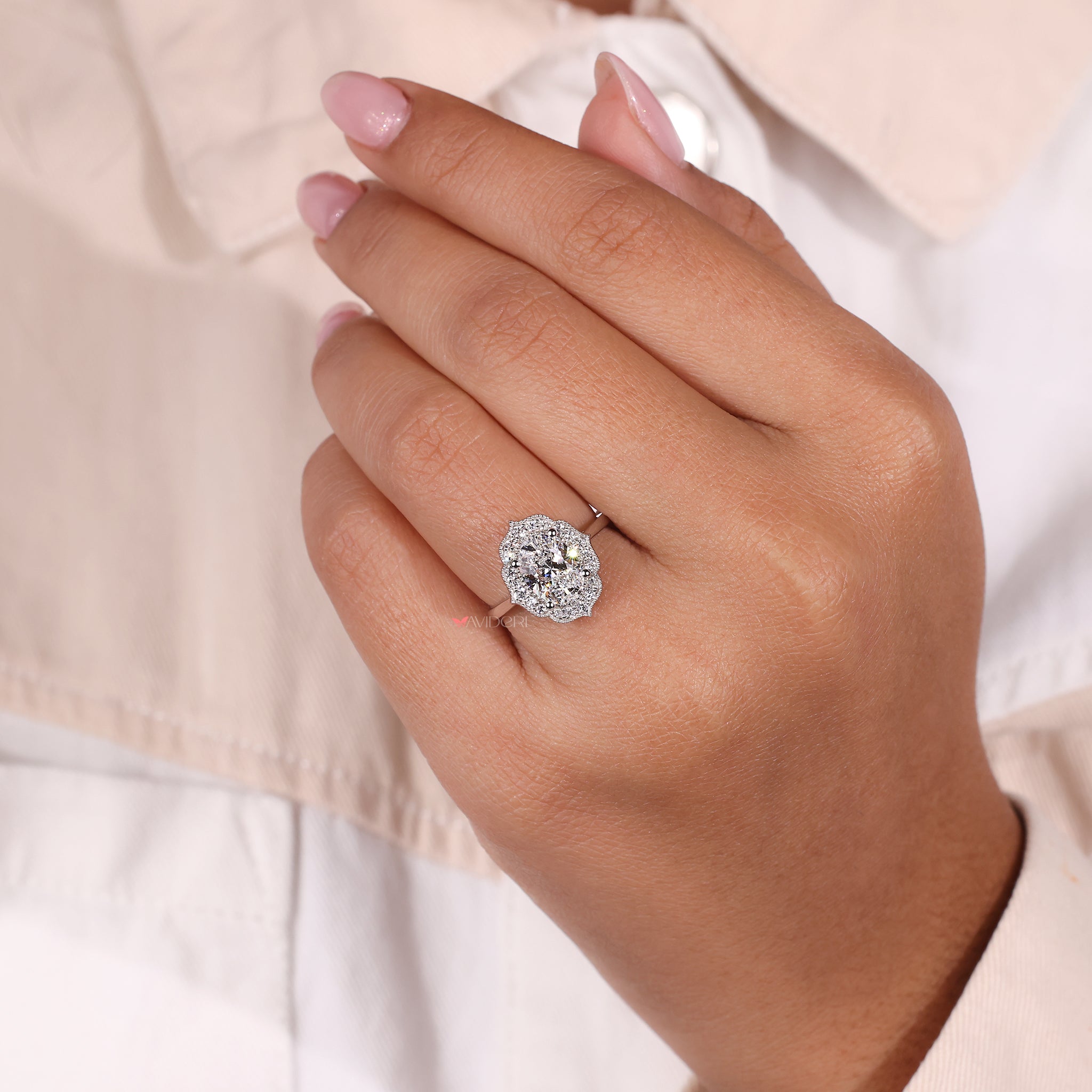 Round cut halo engagement ring in white gold for a modern touch.