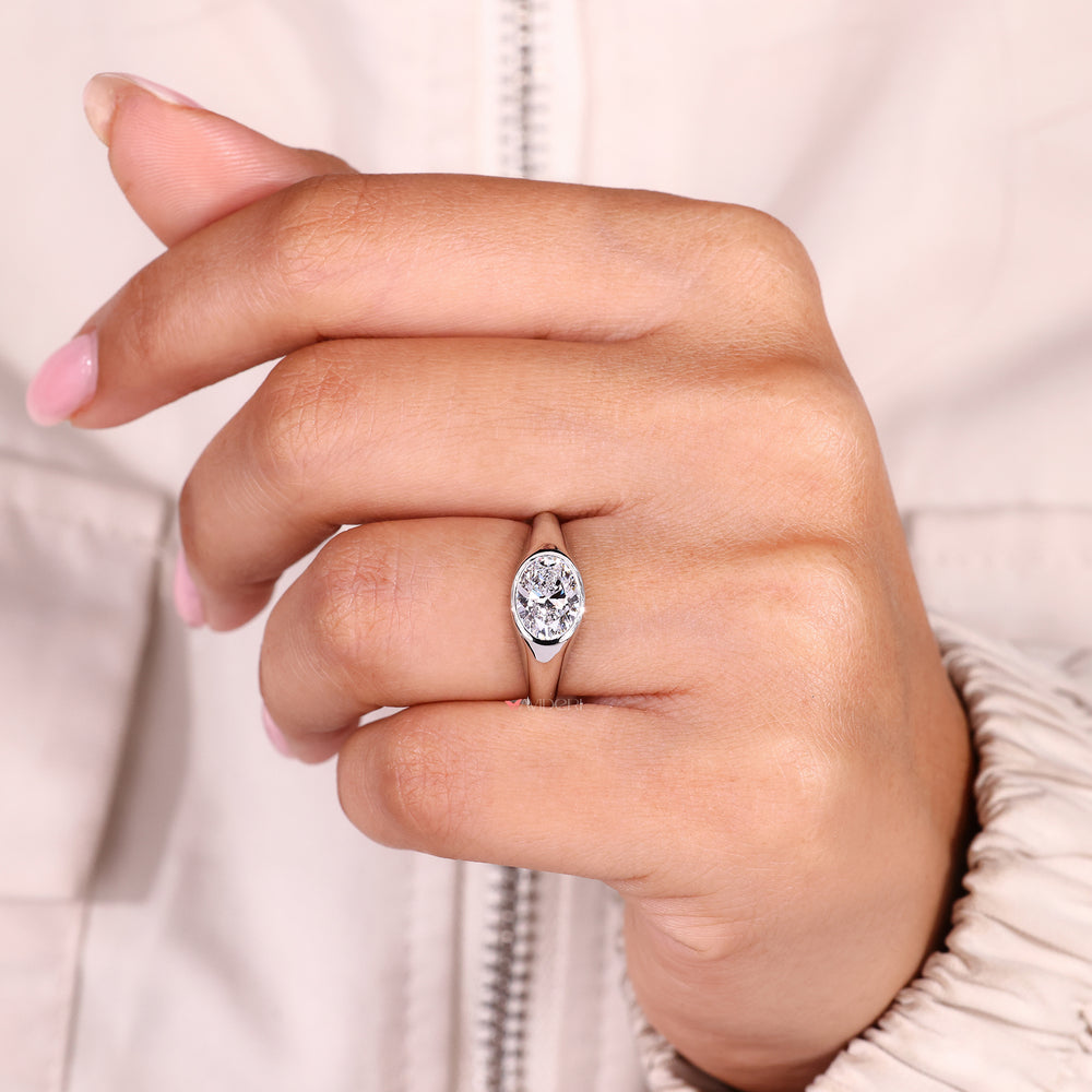 Lab grown oval diamond ring in modern bezel setting.
