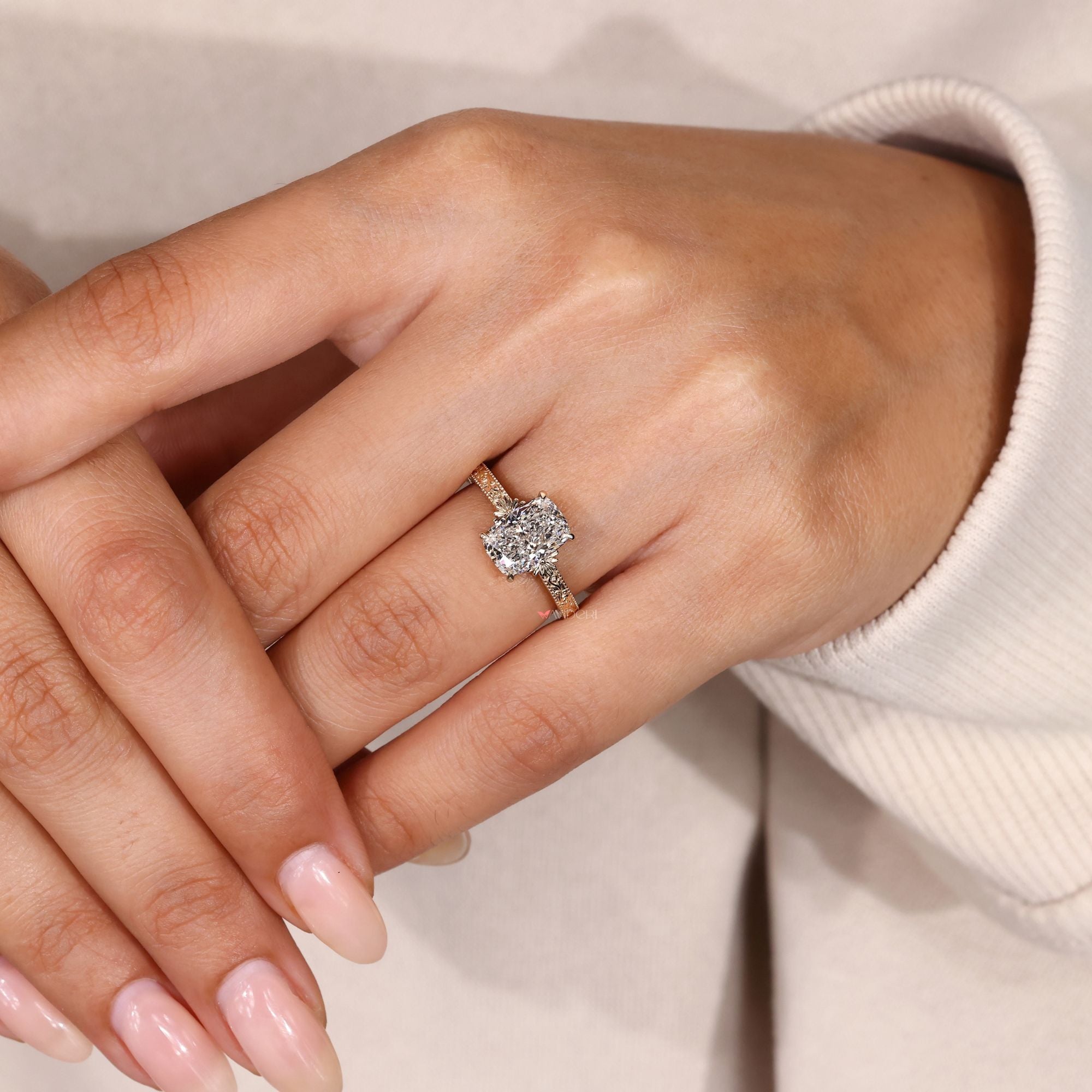 Cushion cut ring with scrollwork and milgrain detail.
