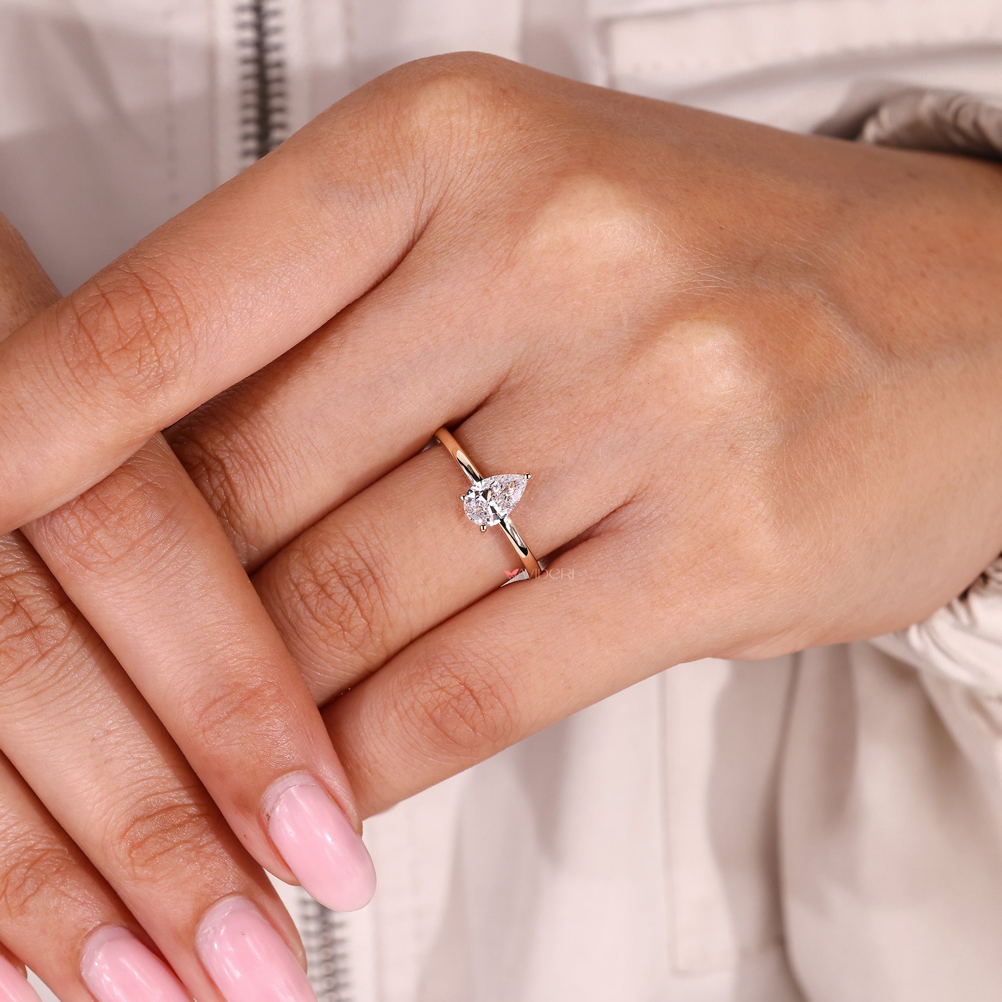 Lab grown pear cut diamond with modern solitaire look.
