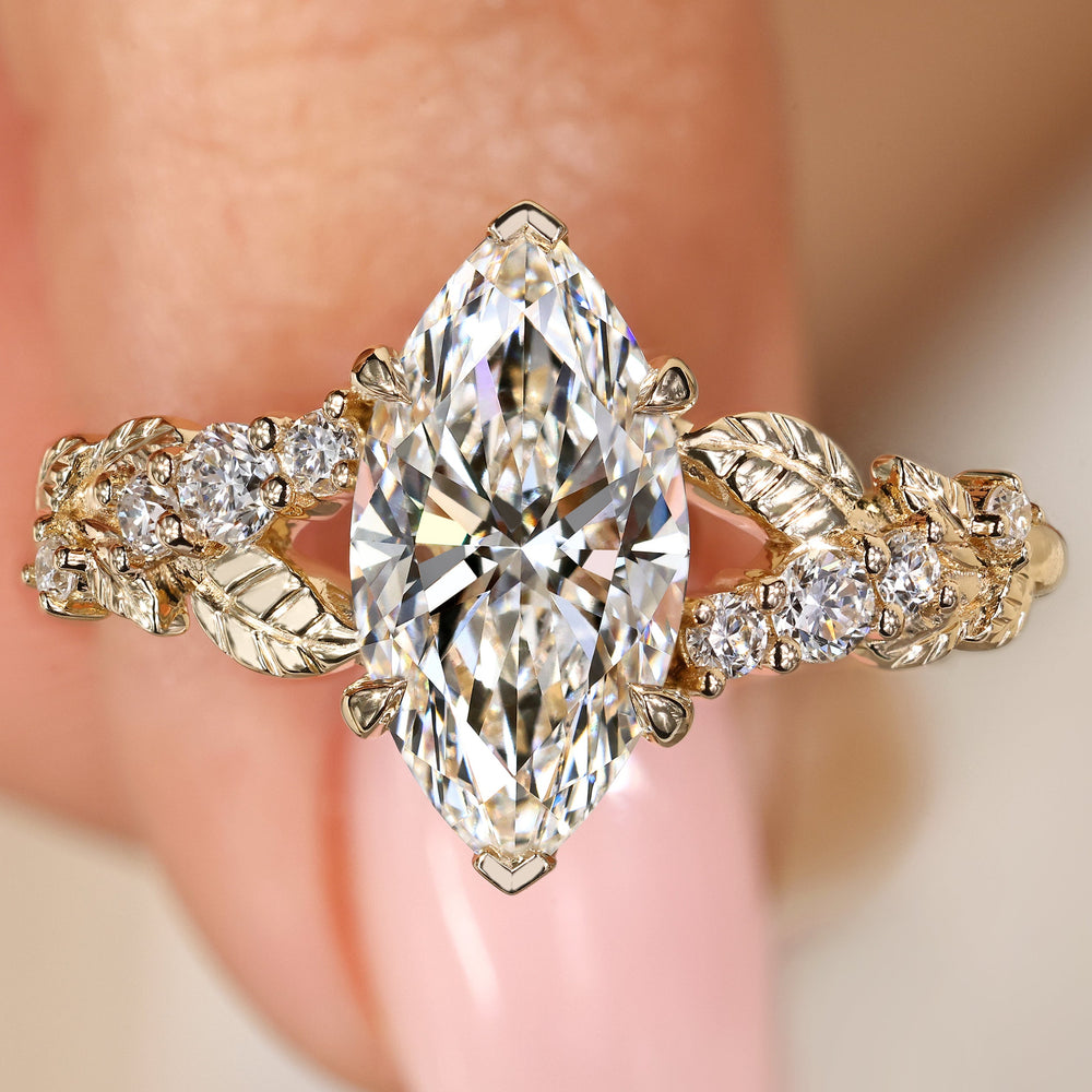 Nature inspired marquise diamond ring with sides.
