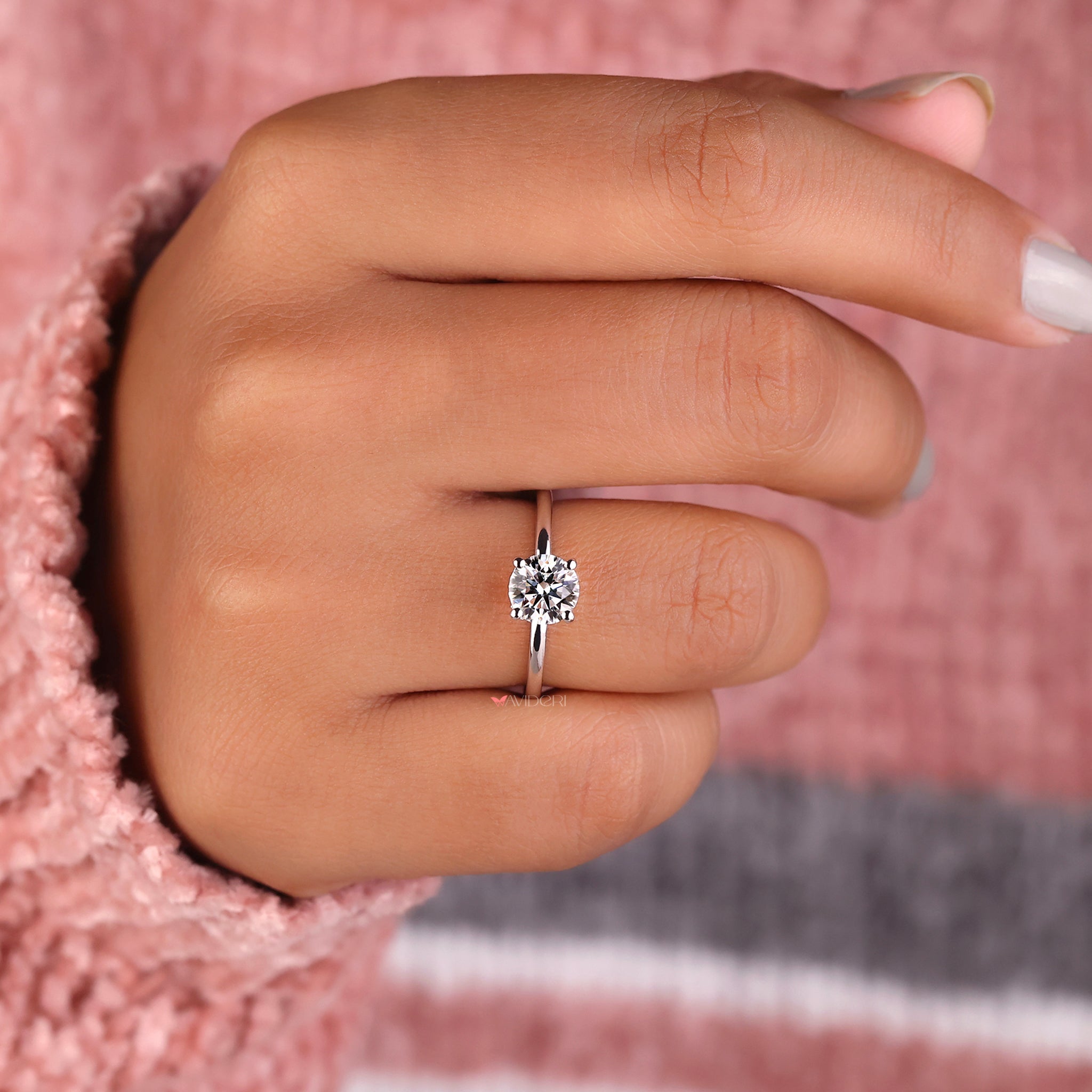 Hidden halo ring featuring a 1 carat solitaire diamond ring for understated glamour.