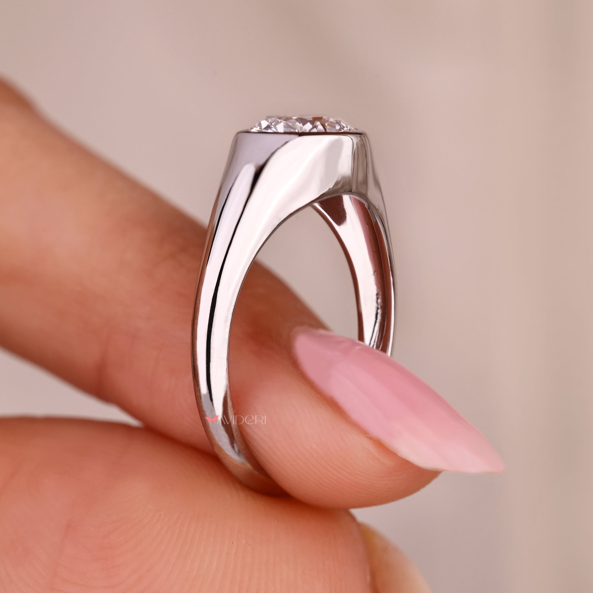 Oval cut solitaire ring with tapered shank design.