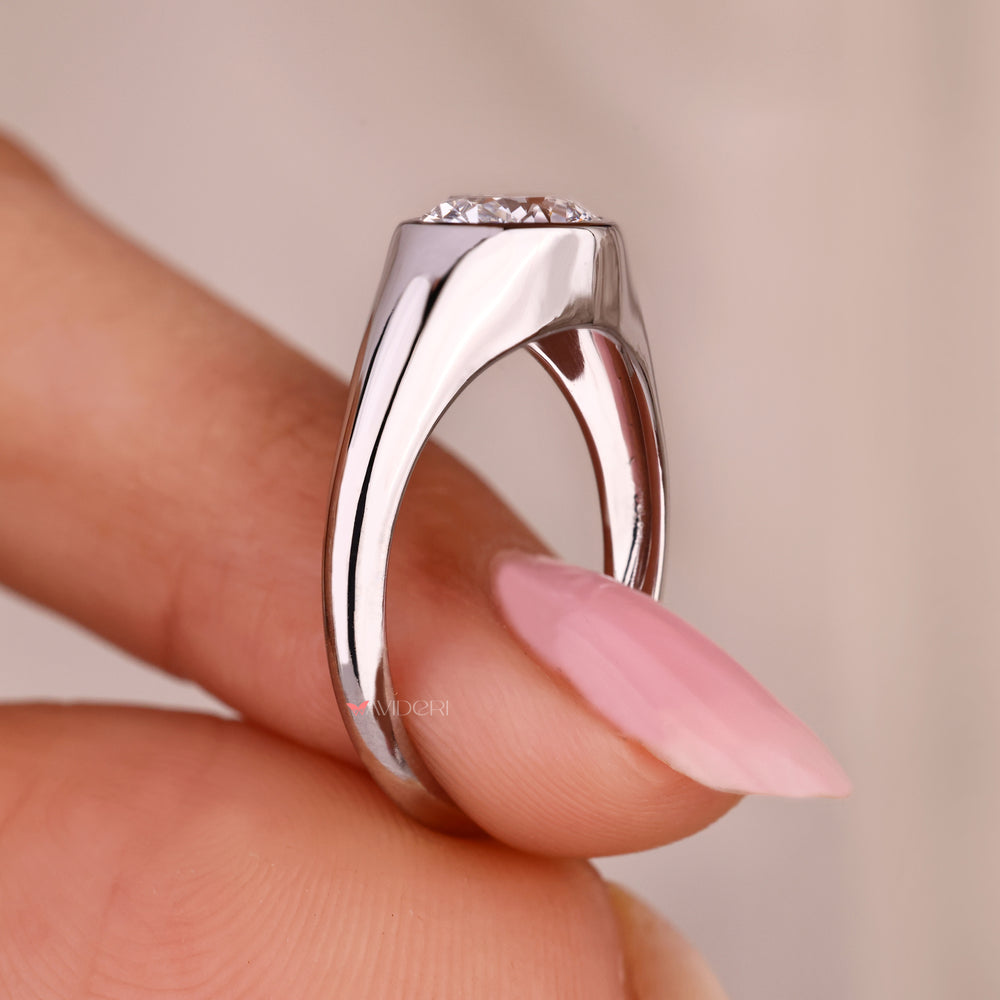 Oval cut solitaire ring with tapered shank design.