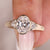 Three stone engagement ring with oval center diamond.