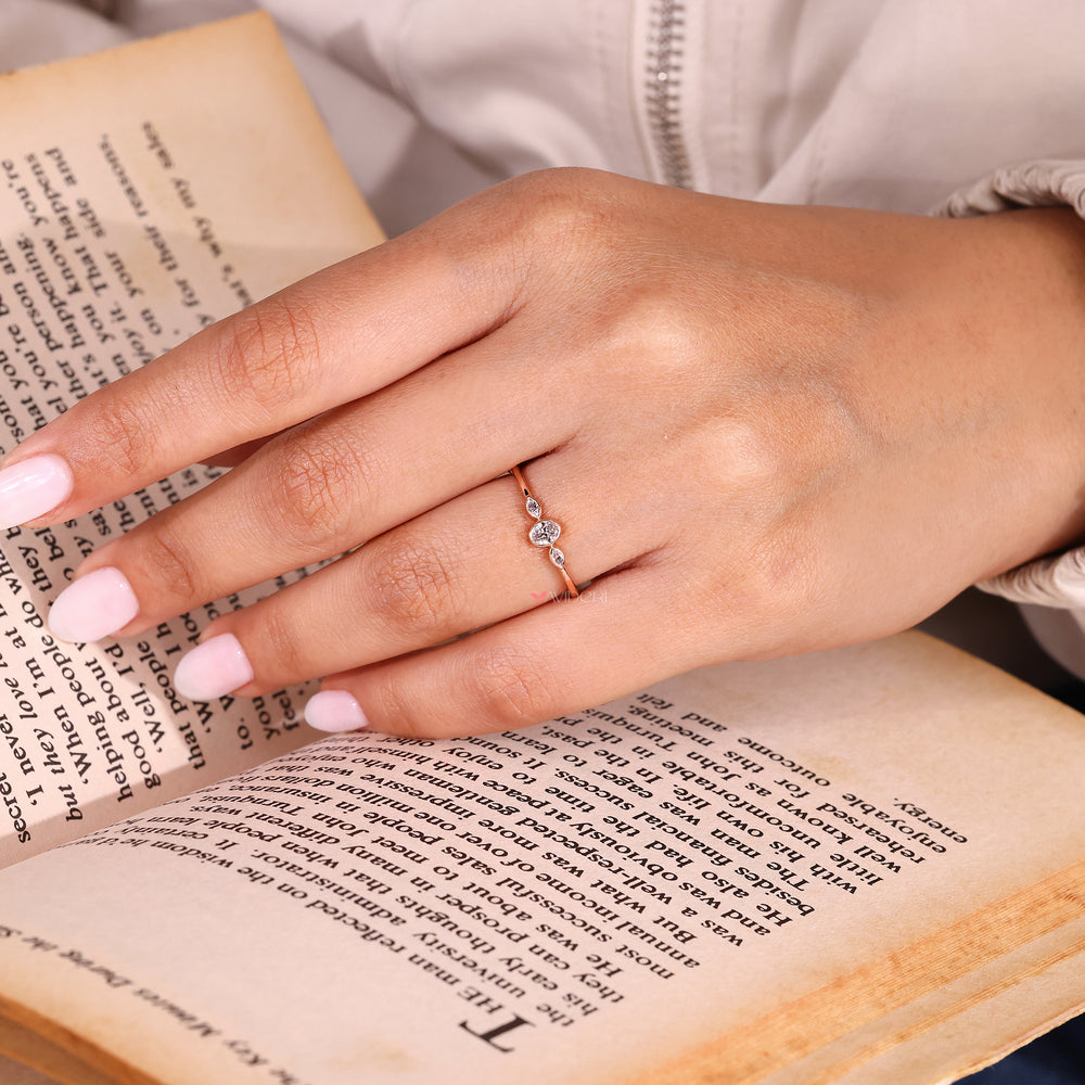 Oval cut diamond three stone ring in bezel setting.
