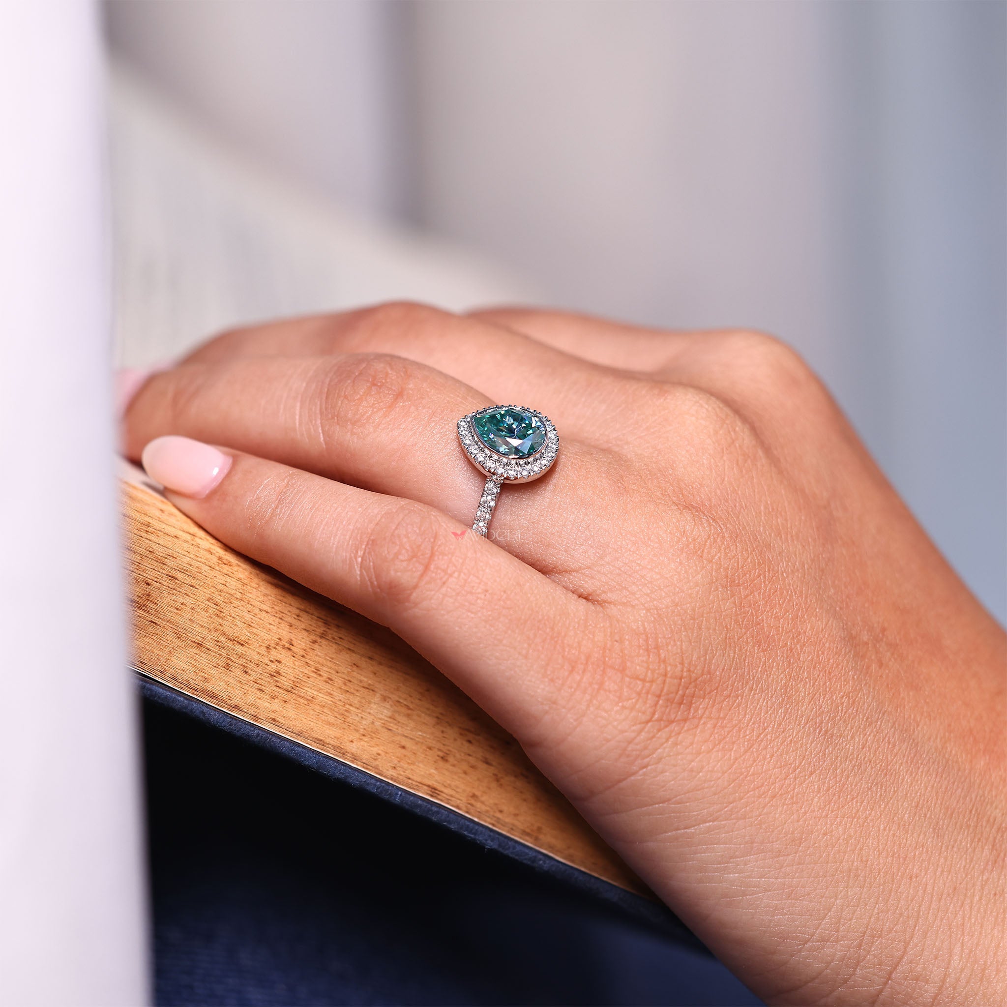 Round cut ring paired with a gold pear cut design for a unique look.