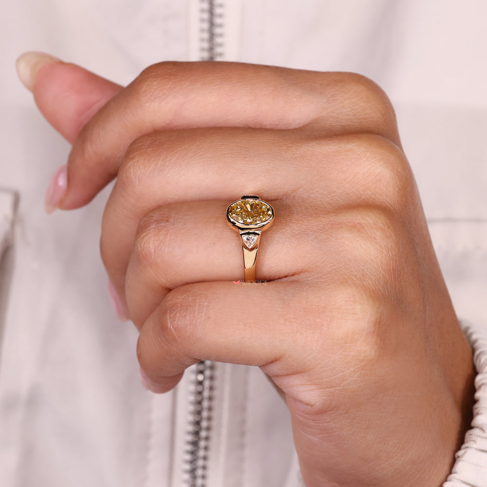 Bezel setting oval diamond ring tapered shank.
