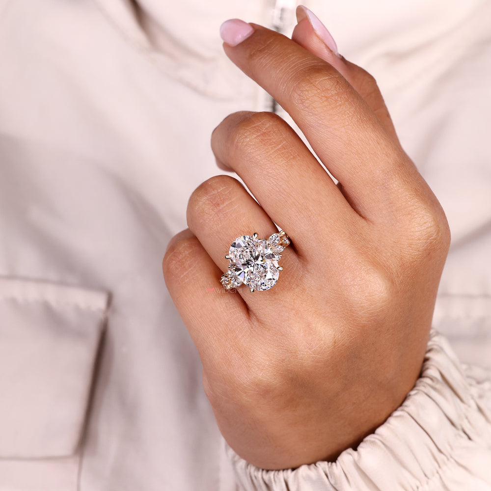 Oval cut diamond ring with round side accents.
