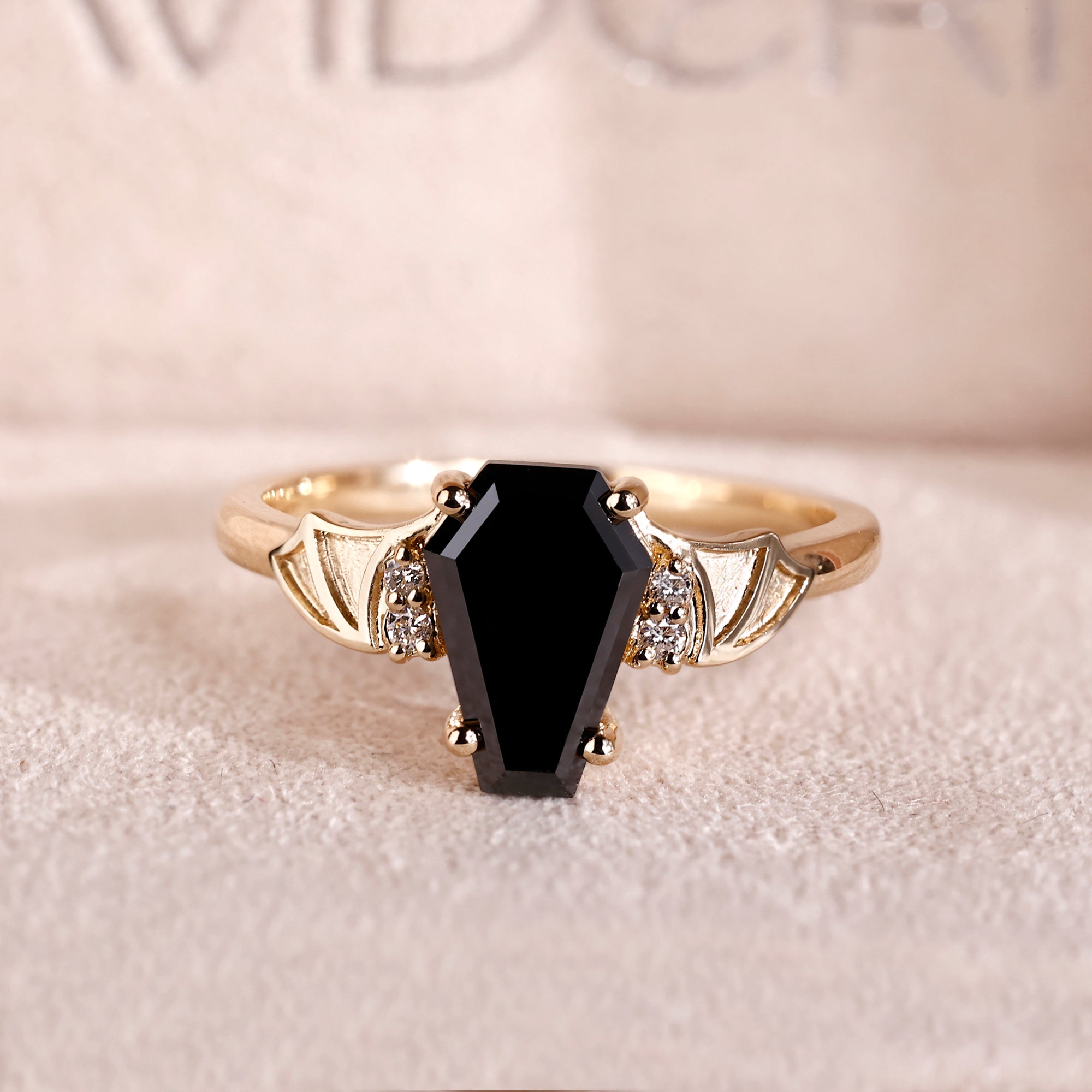 Coffin cut engagement ring with black coffin ring.