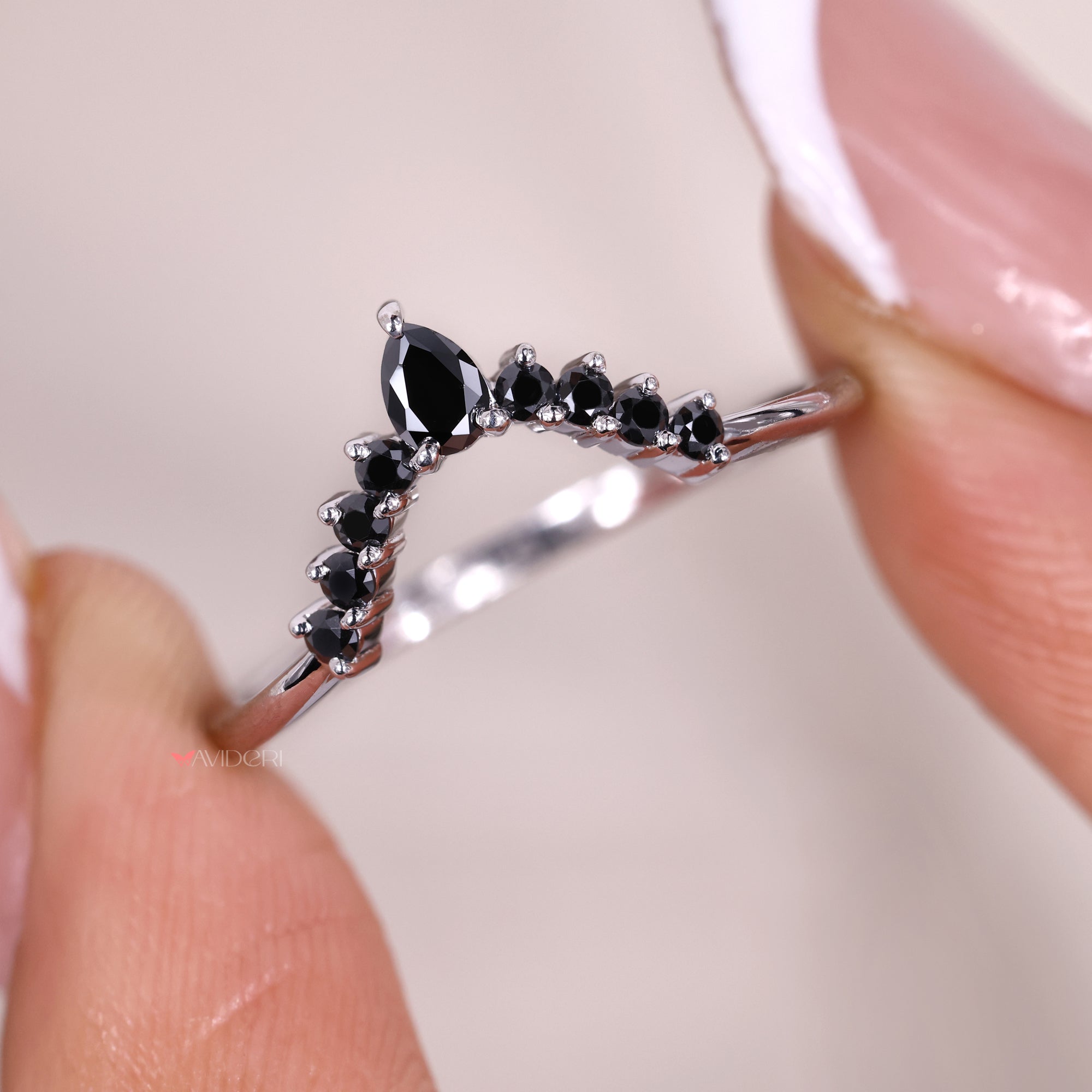 Round cut side stone in chevron wedding band.