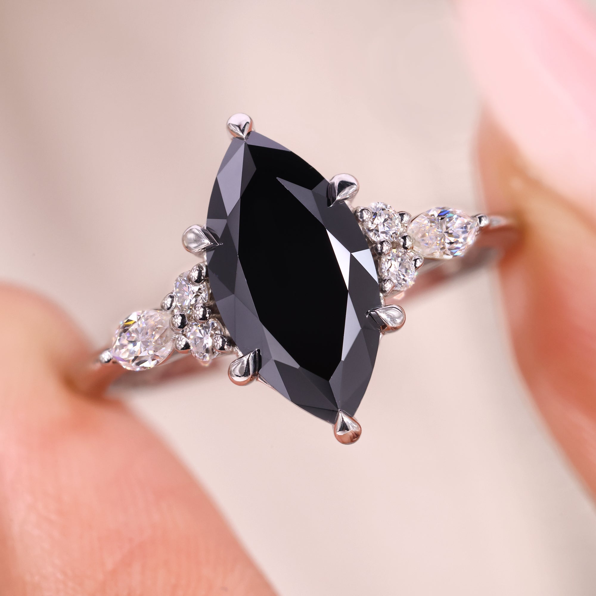 Black marquise engagement ring with muse setting ring.