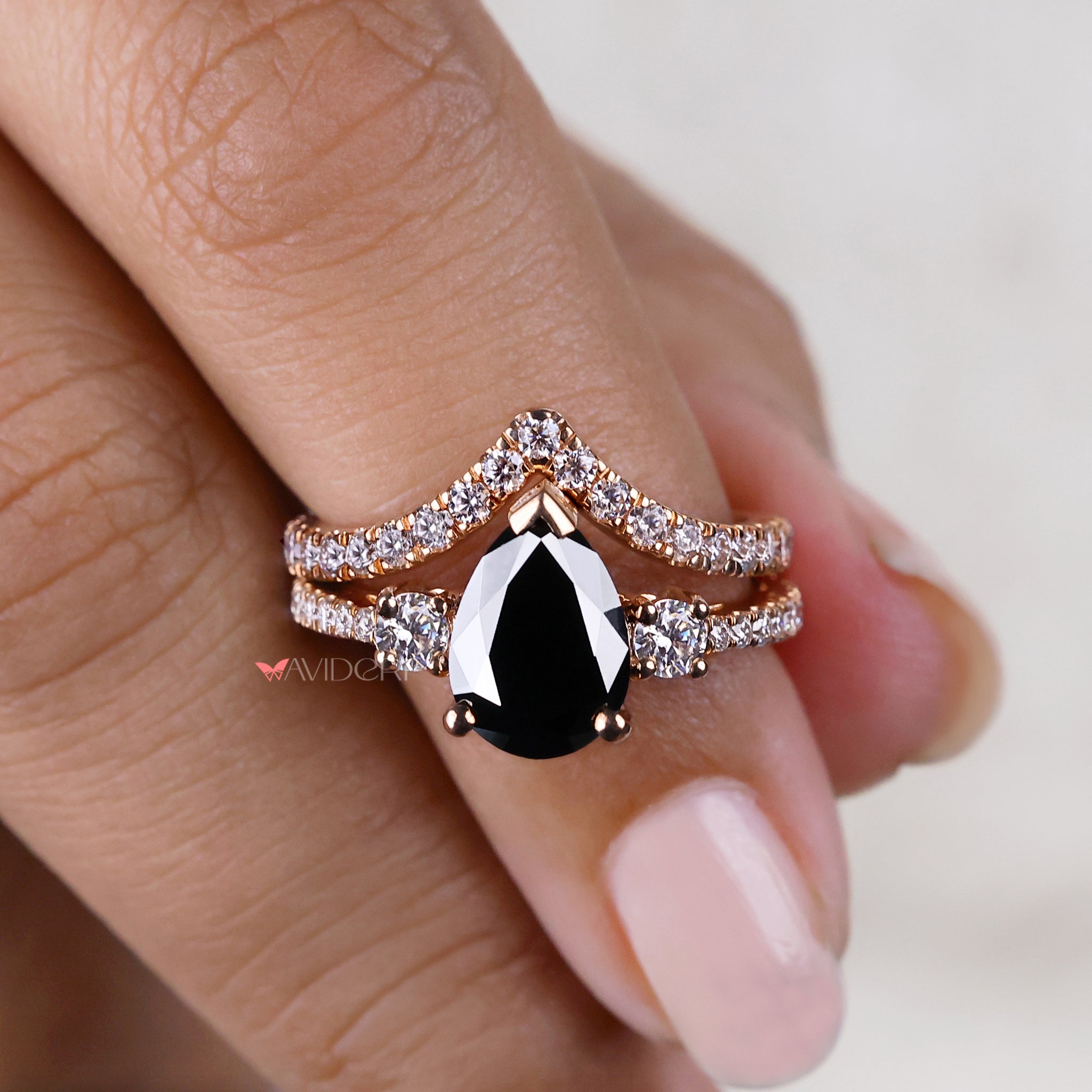 Round cut engagement ring paired with a pear shape ring for contrast.