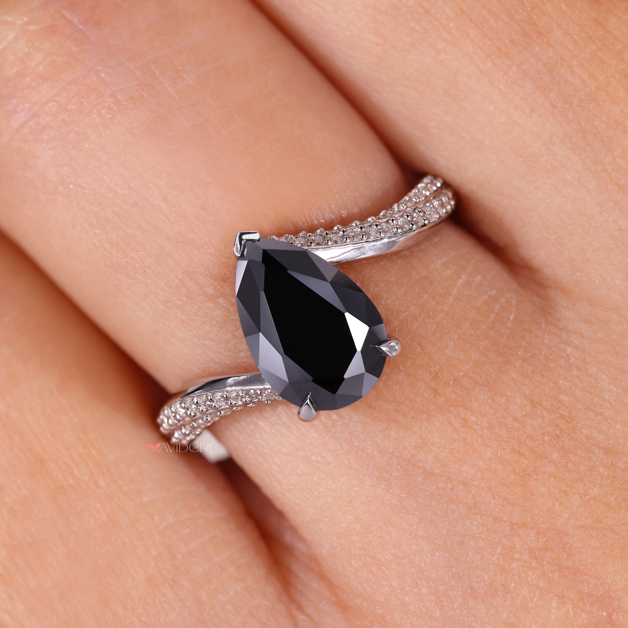 Pear cut moissanite ring in a secure bypass setting for added elegance.