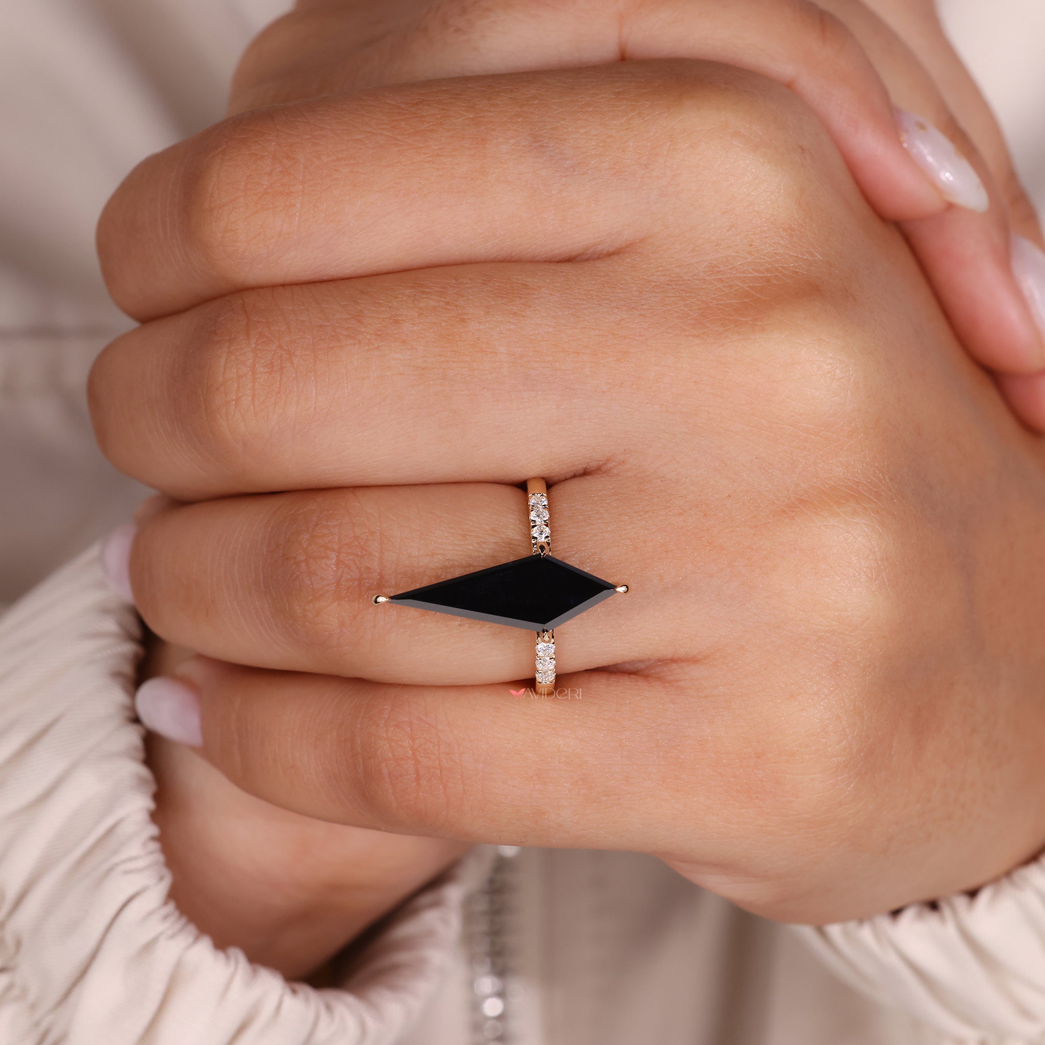 Pave engagement ring featuring a kite cut black moissanite.
