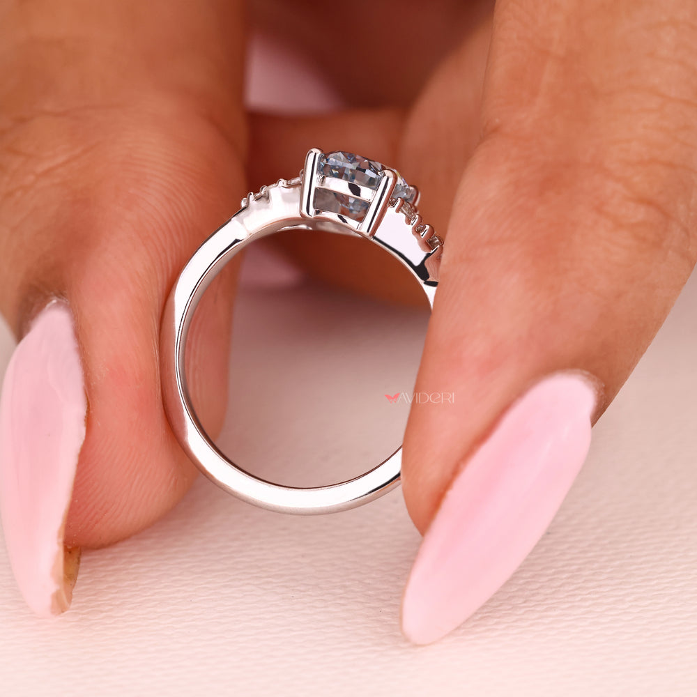 Oval blue diamond ring basket setting style.
