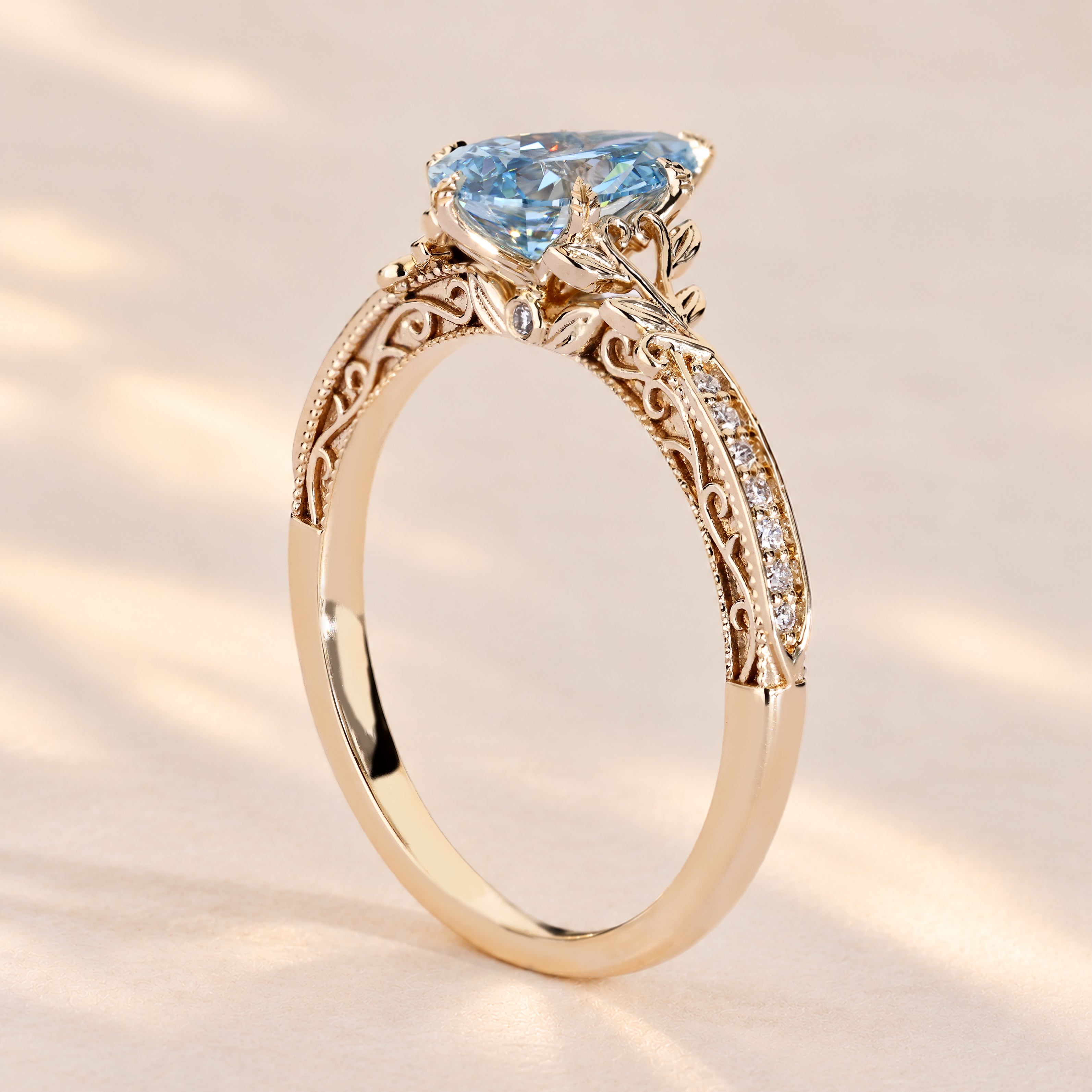 Blue diamond engagement ring with tulip basket setting.
