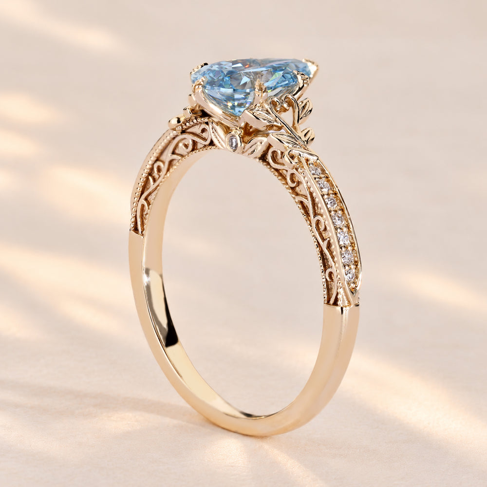Blue diamond engagement ring with tulip basket setting.
