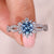Halo diamond ring with bright blue diamond center.