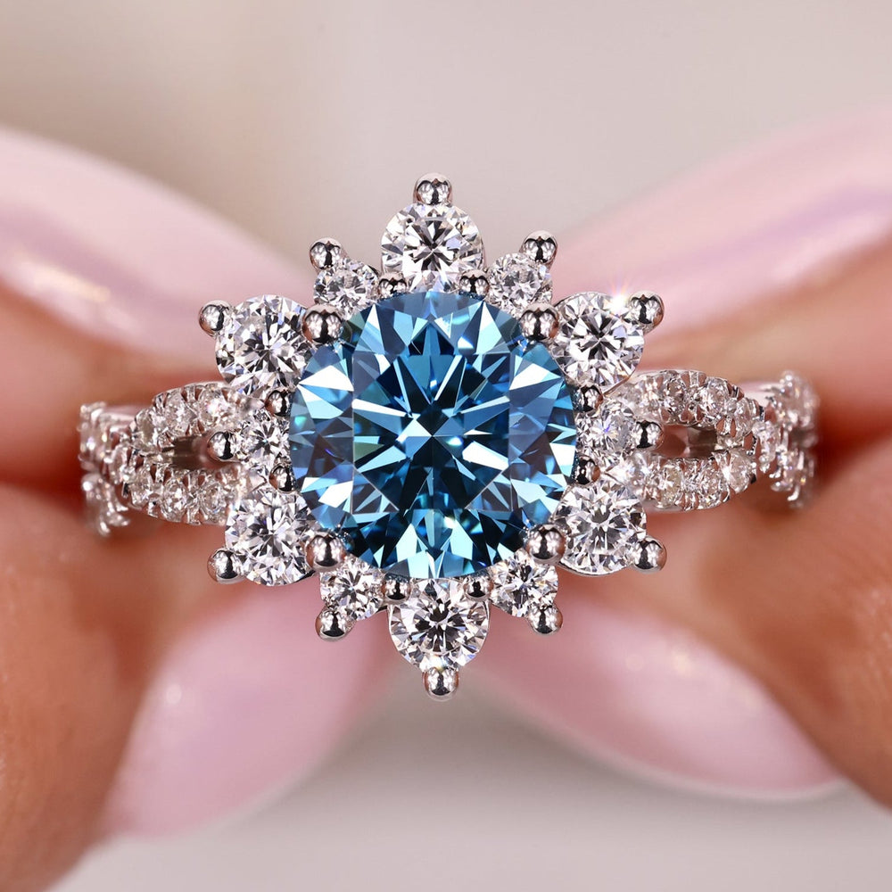 round blue diamond engagement ring with prong setting in white gold.