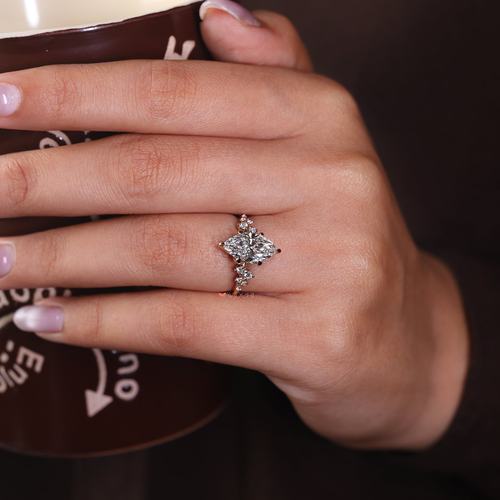 Marquise diamond ring with a cluster setting, perfect for a bold, stylish look.