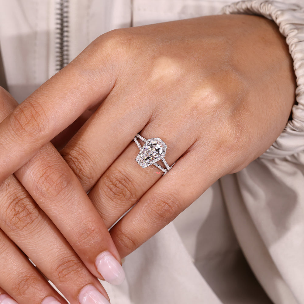 Coffin cut diamond ring with four claw prongs.
