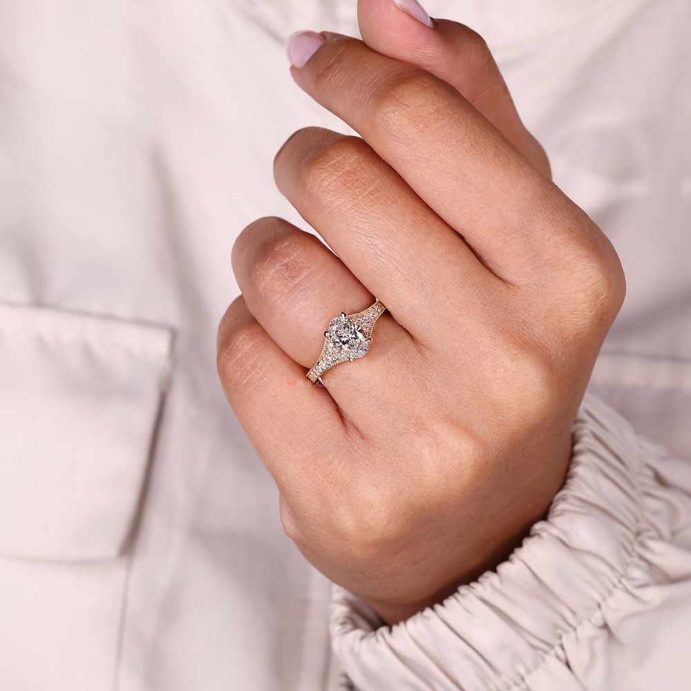 Oval ring with tapered pave and milgrain.
