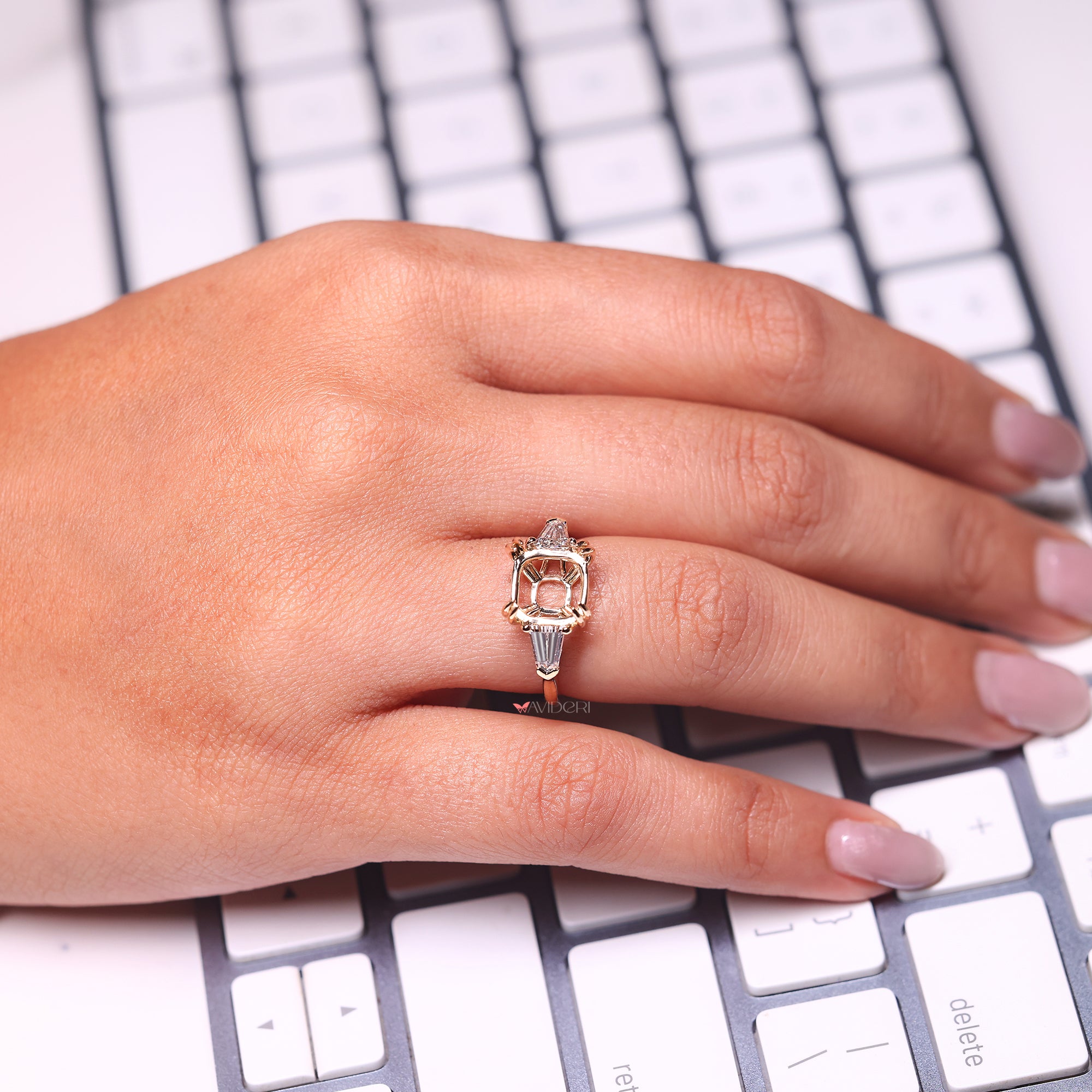Handmade yellow gold engagement ring with bullet cut side stones.
