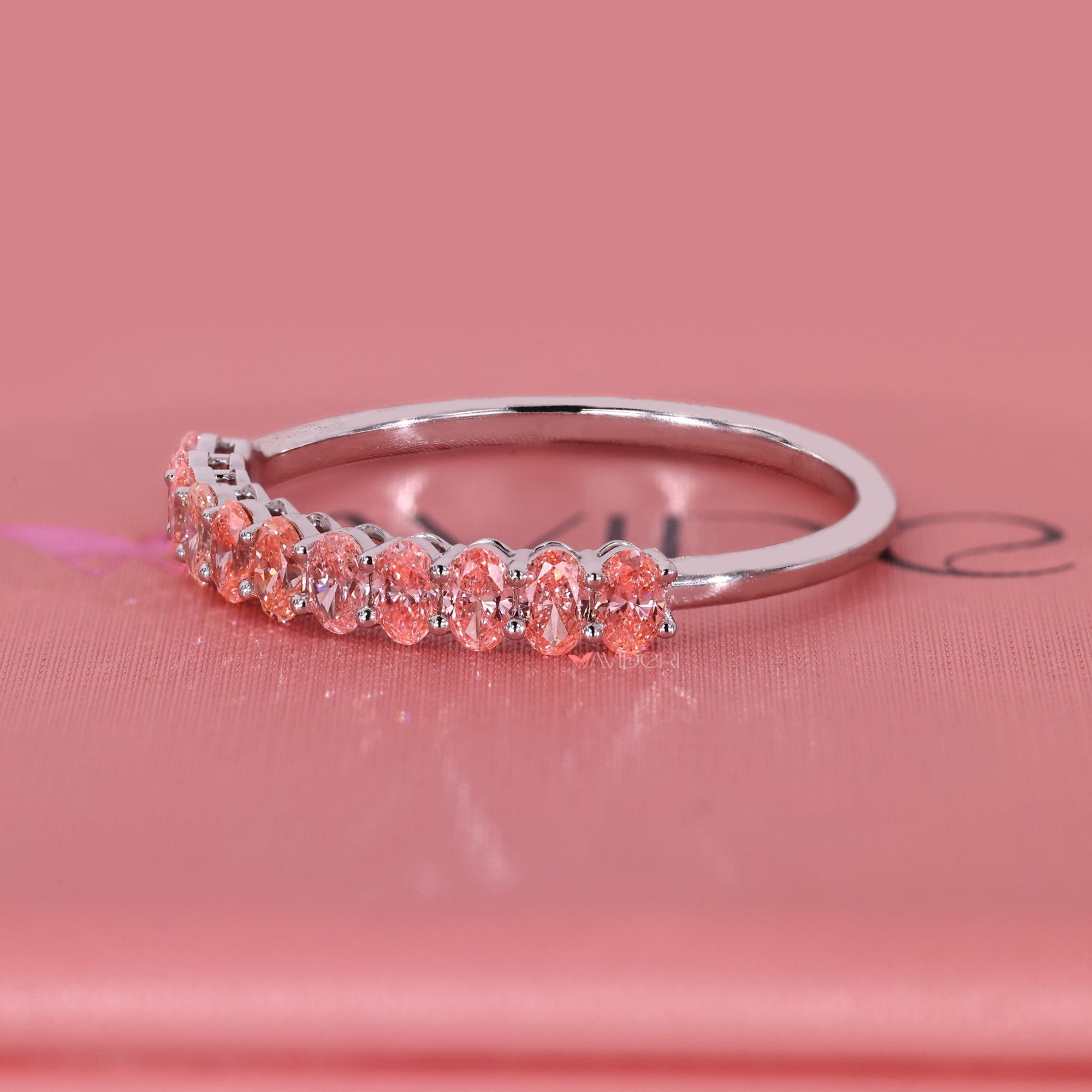 Handmade jewelry wedding band with oval pink diamonds.