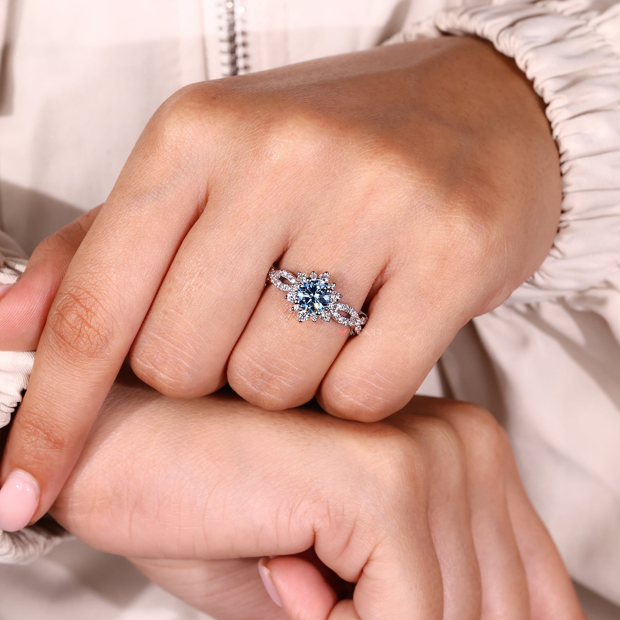 Round cut diamond ring in white gold with halo design.

