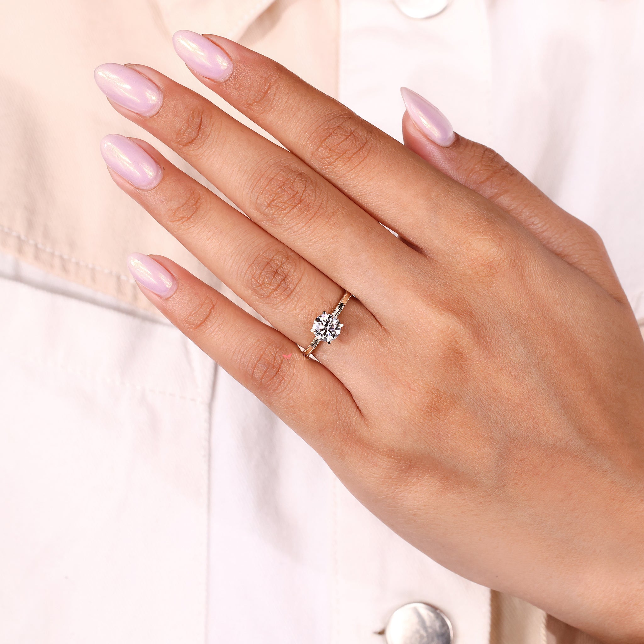 Diamond ring for engagement with classic round shape.