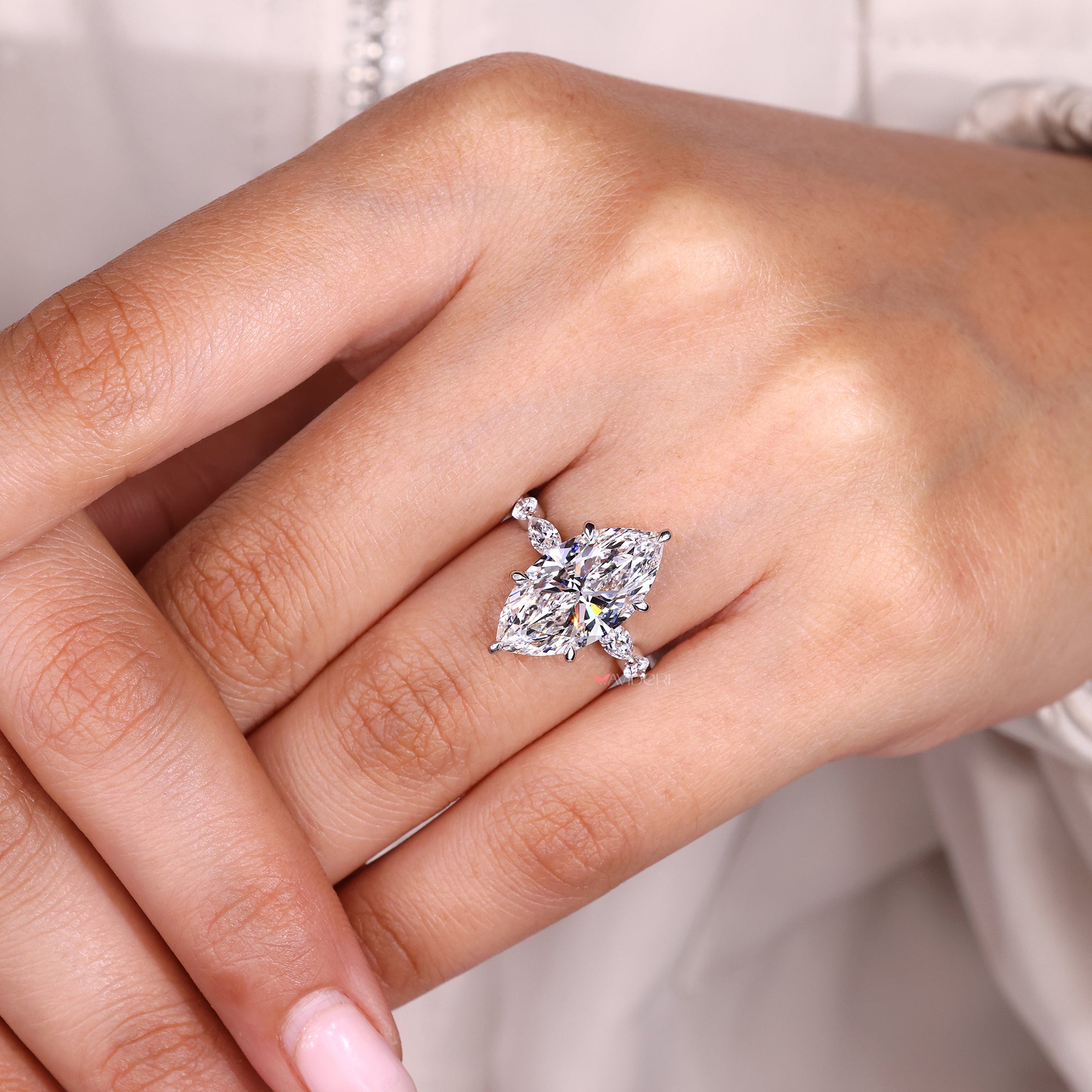 Lab grown diamond marquise ring with round side stones.