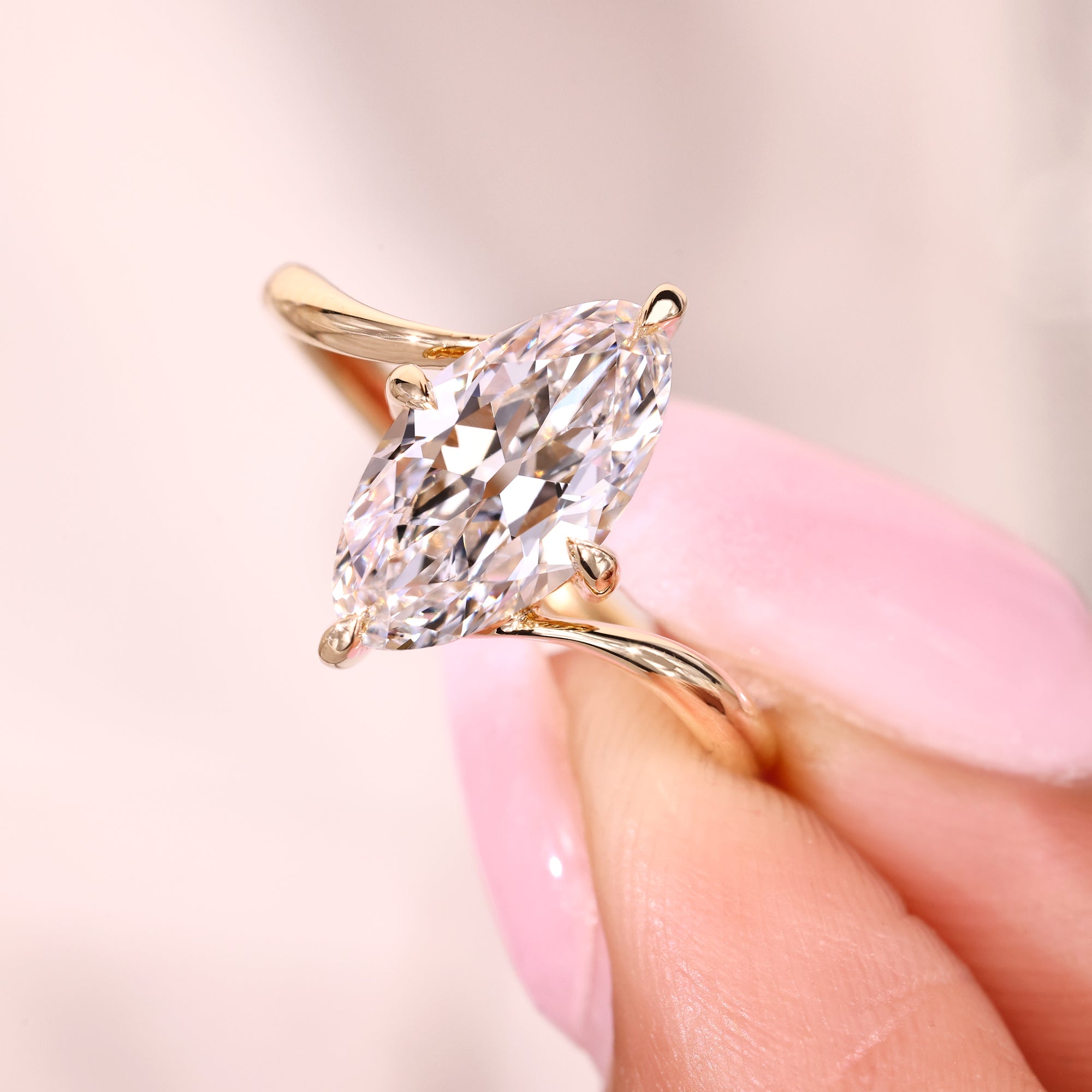 Compass prong marquise solitaire diamond ring.