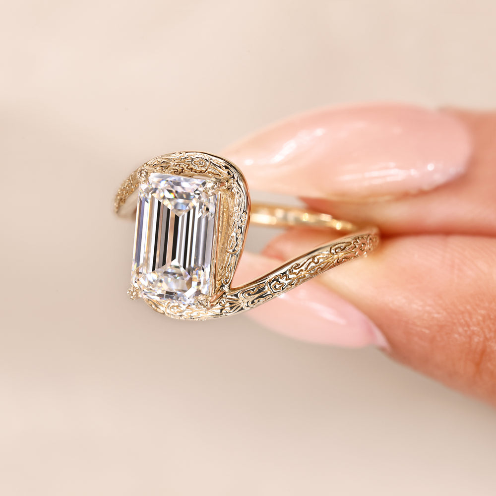 Handmade emerald cut ring with engraved shank.
