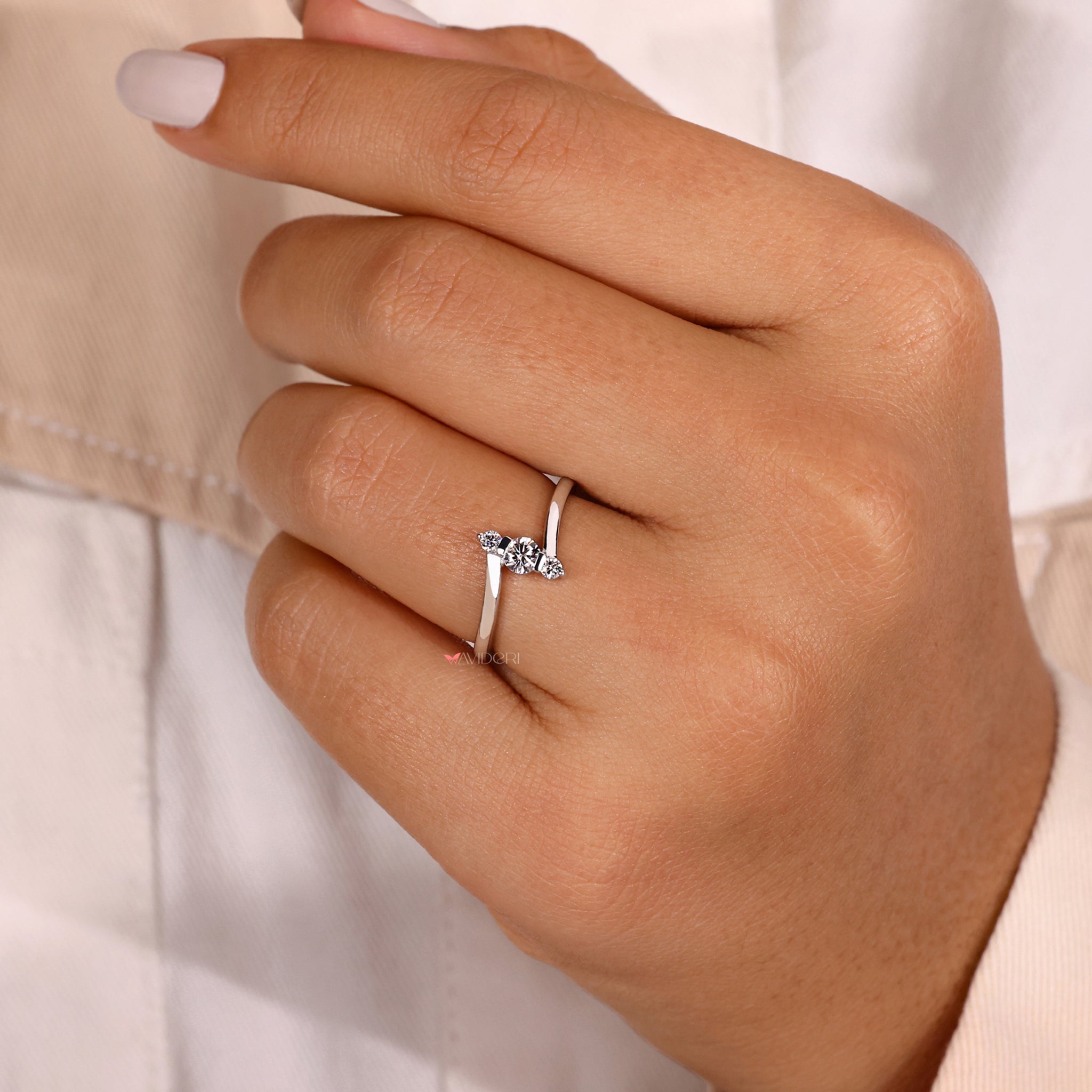 Bypass ring setting with a three stone diamond ring.
