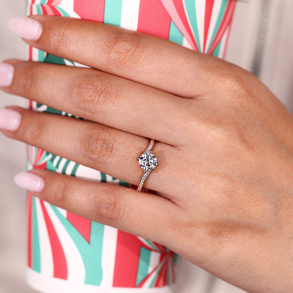 Round diamond ring with bypass and pave design.
