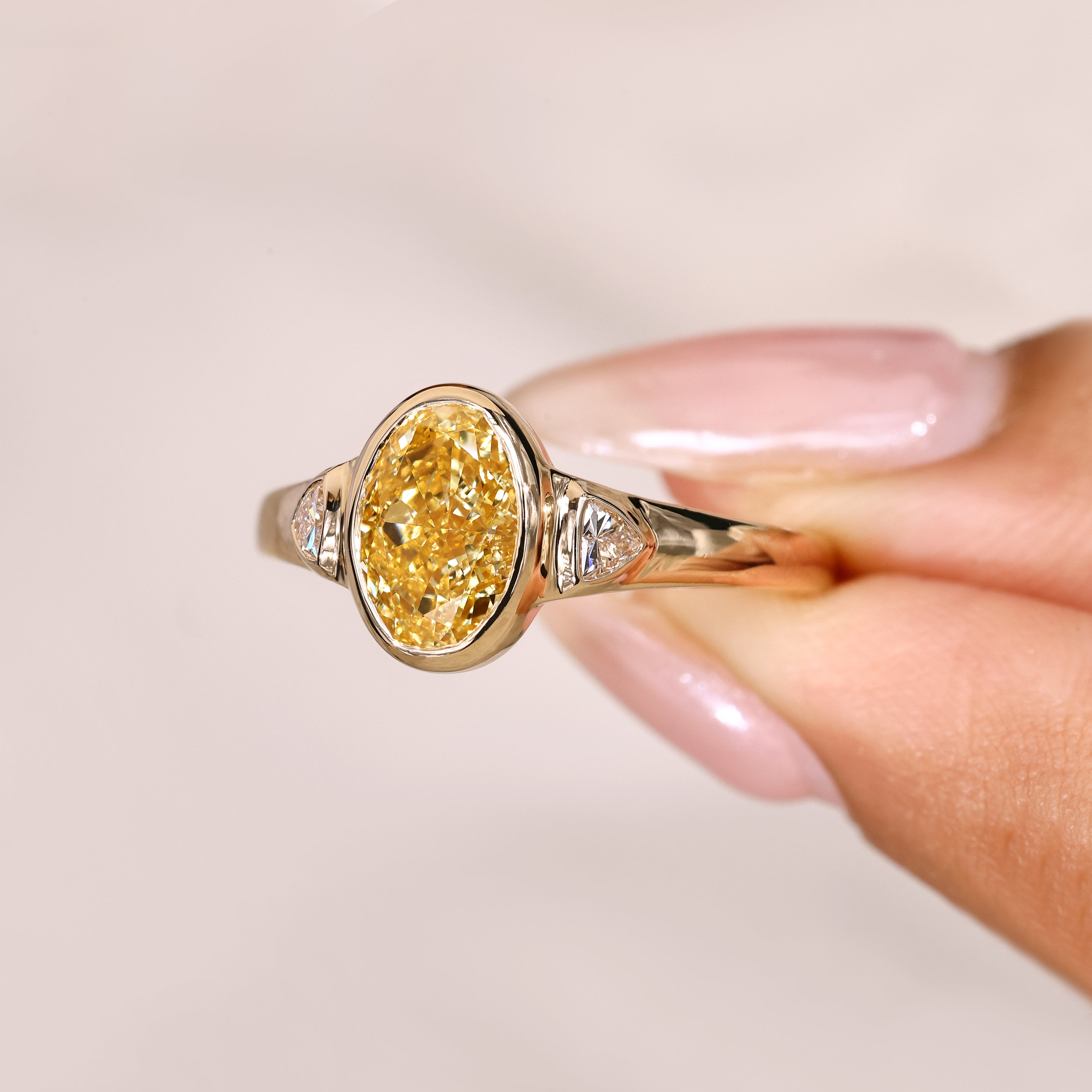 Oval ring with cathedral setting and side stones.
