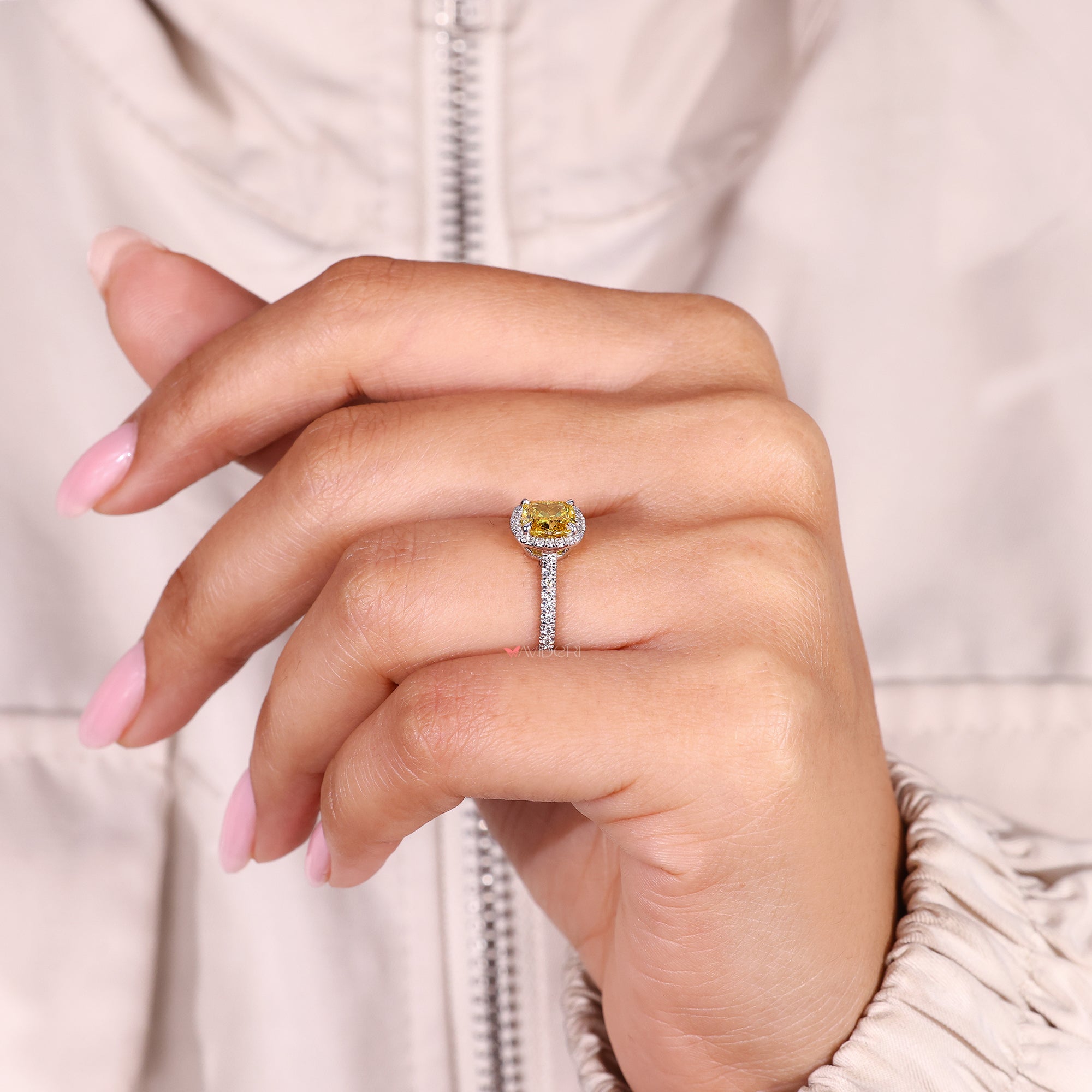 Handmade cushion cut diamond ring with four claw prongs.
