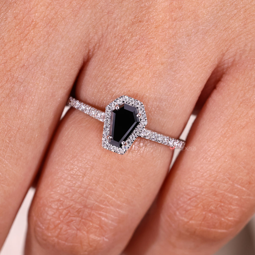 Coffin cut ring with pave halo and cathedral style.