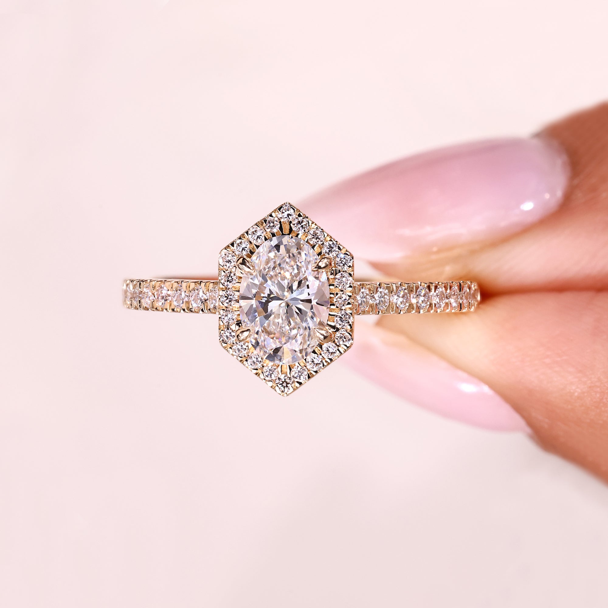 Oval ring with round diamond halo design.
