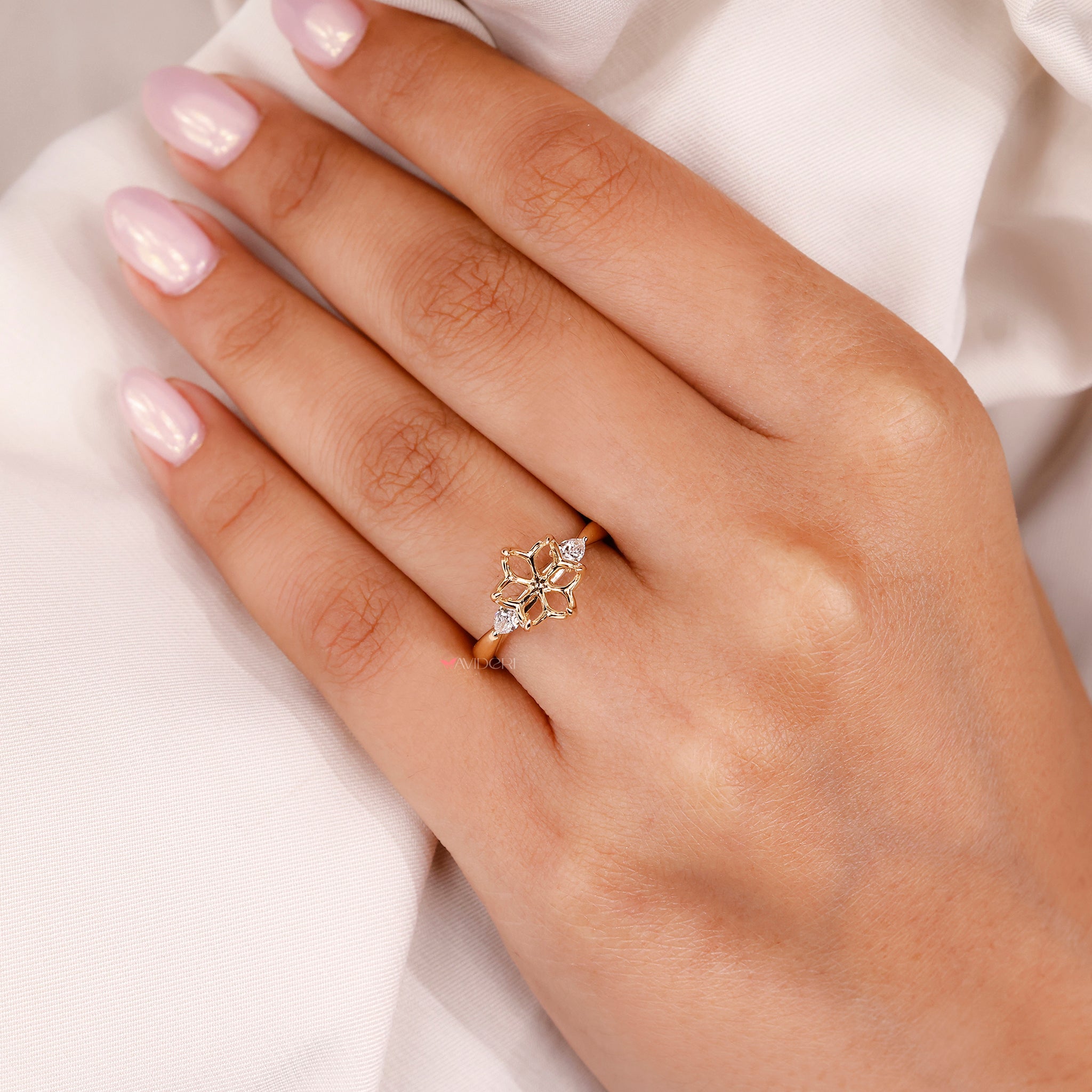 Round cut pink peekaboo setting in a unique flower engagement ring style.
