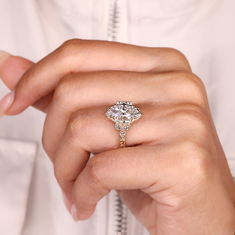 Marquise diamond ring with double prongs and side stones
