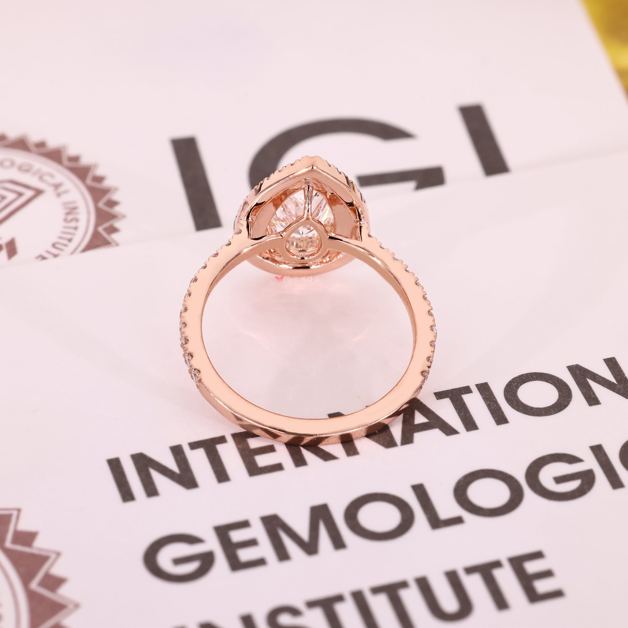 Rose gold ring with halo diamond design.