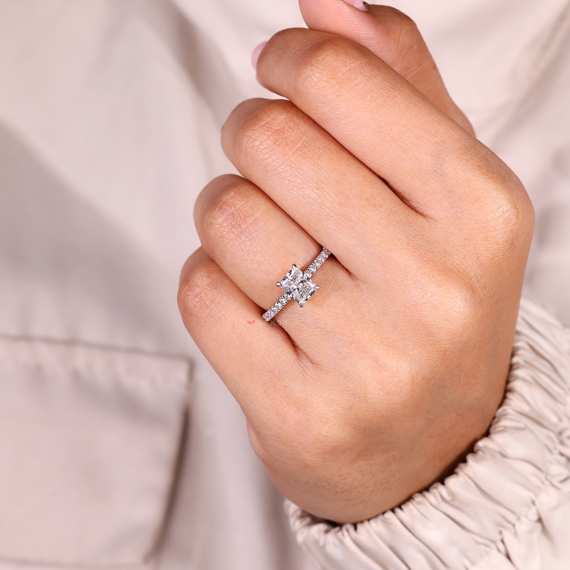 Radiant cut ring with four claw prong setting.