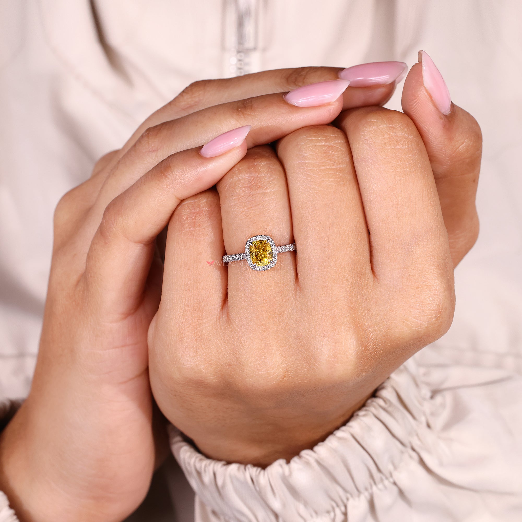 Yellow diamond cushion cut ring with round pave accents.
