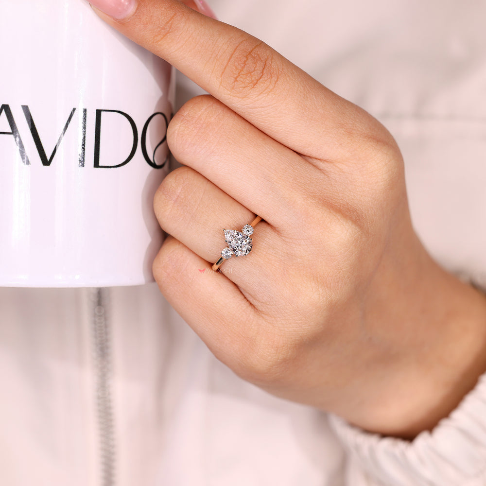 Three stone pear diamond ring with cathedral setting design
