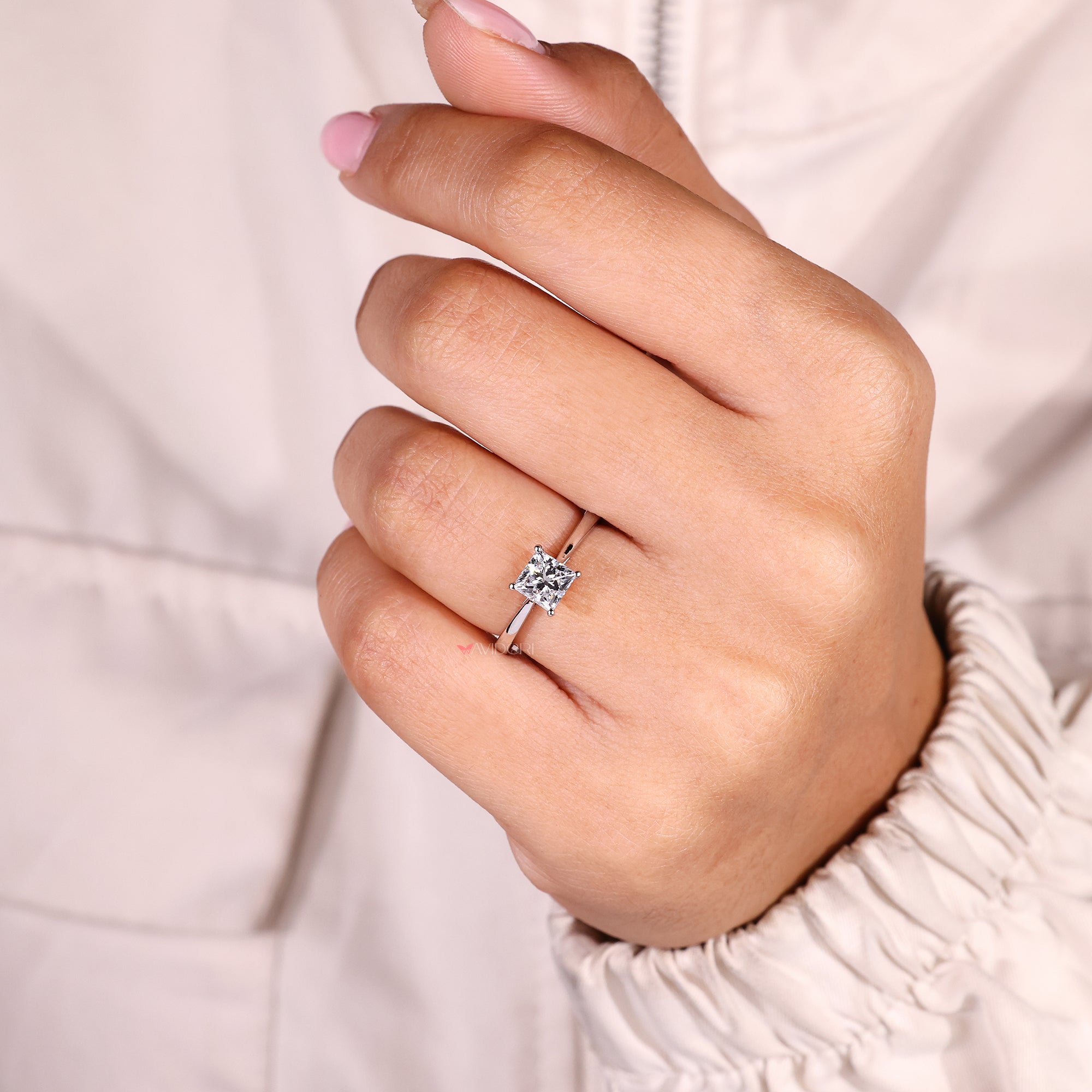 Princess cut solitaire ring with classic cathedral setting.
