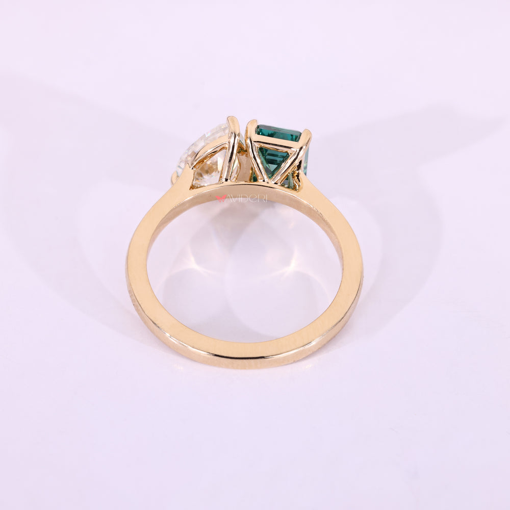 Cathedral setting ring with pear and emerald cut moissanite.