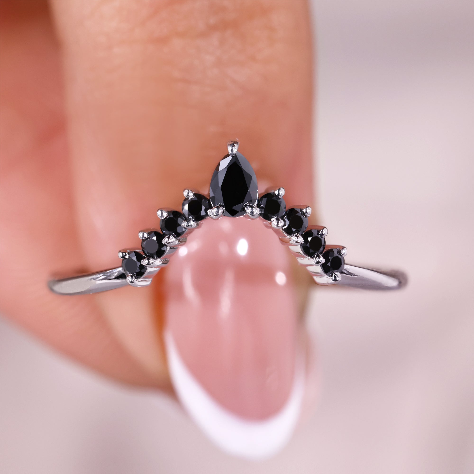 Pear cut wedding band with round cut side stone.